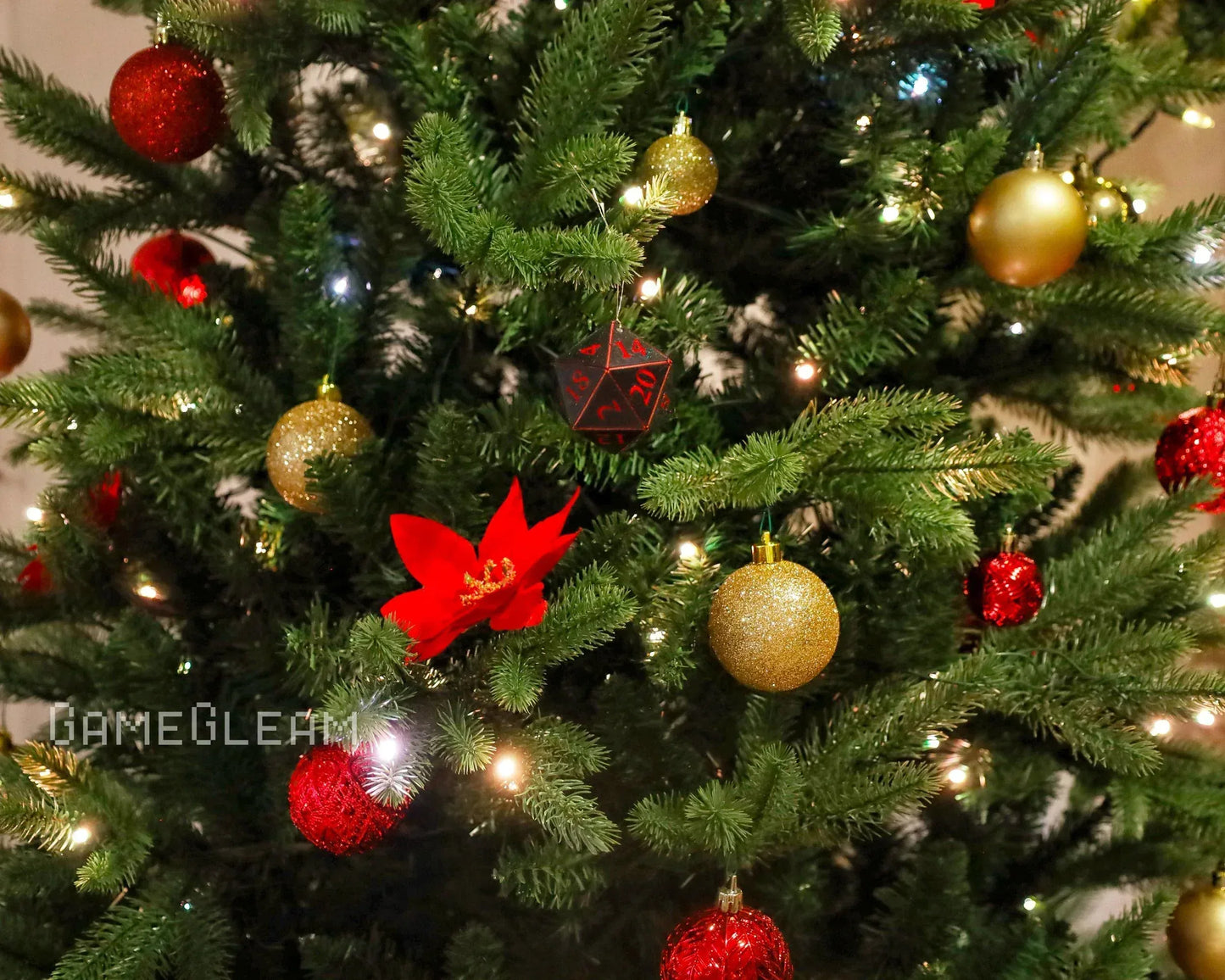 Christmas tree with red and gold ornaments and a large black polyhedral dice decoration