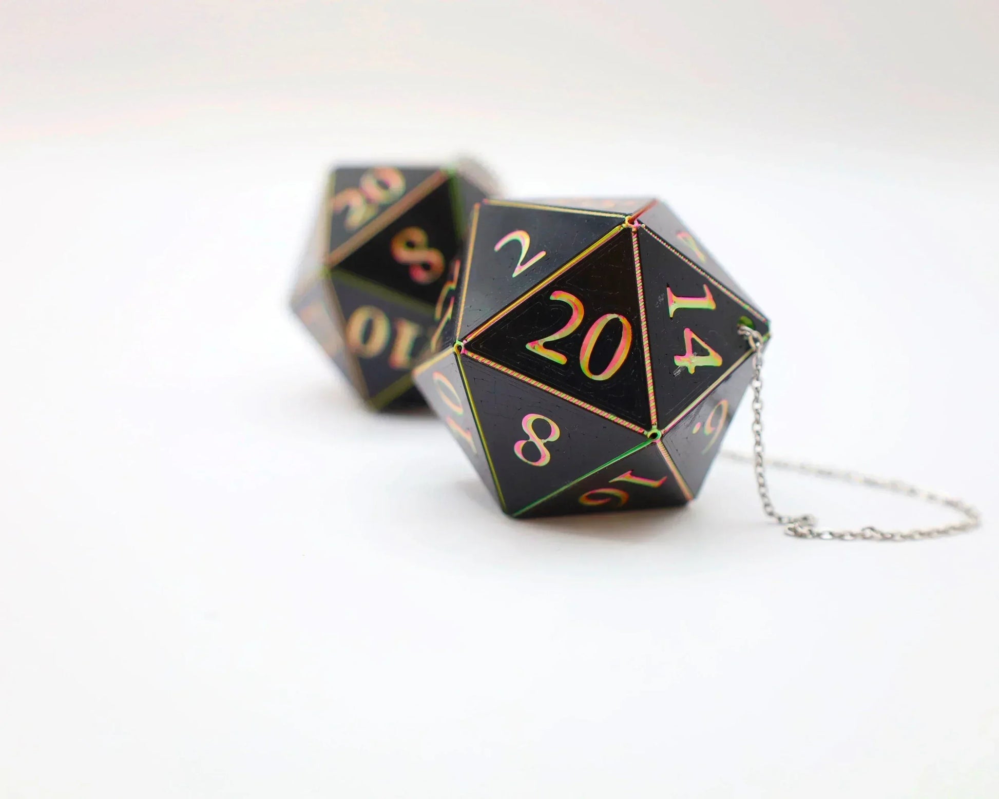Handmade holographic black twenty-sided gaming dice car charm with chain on white background