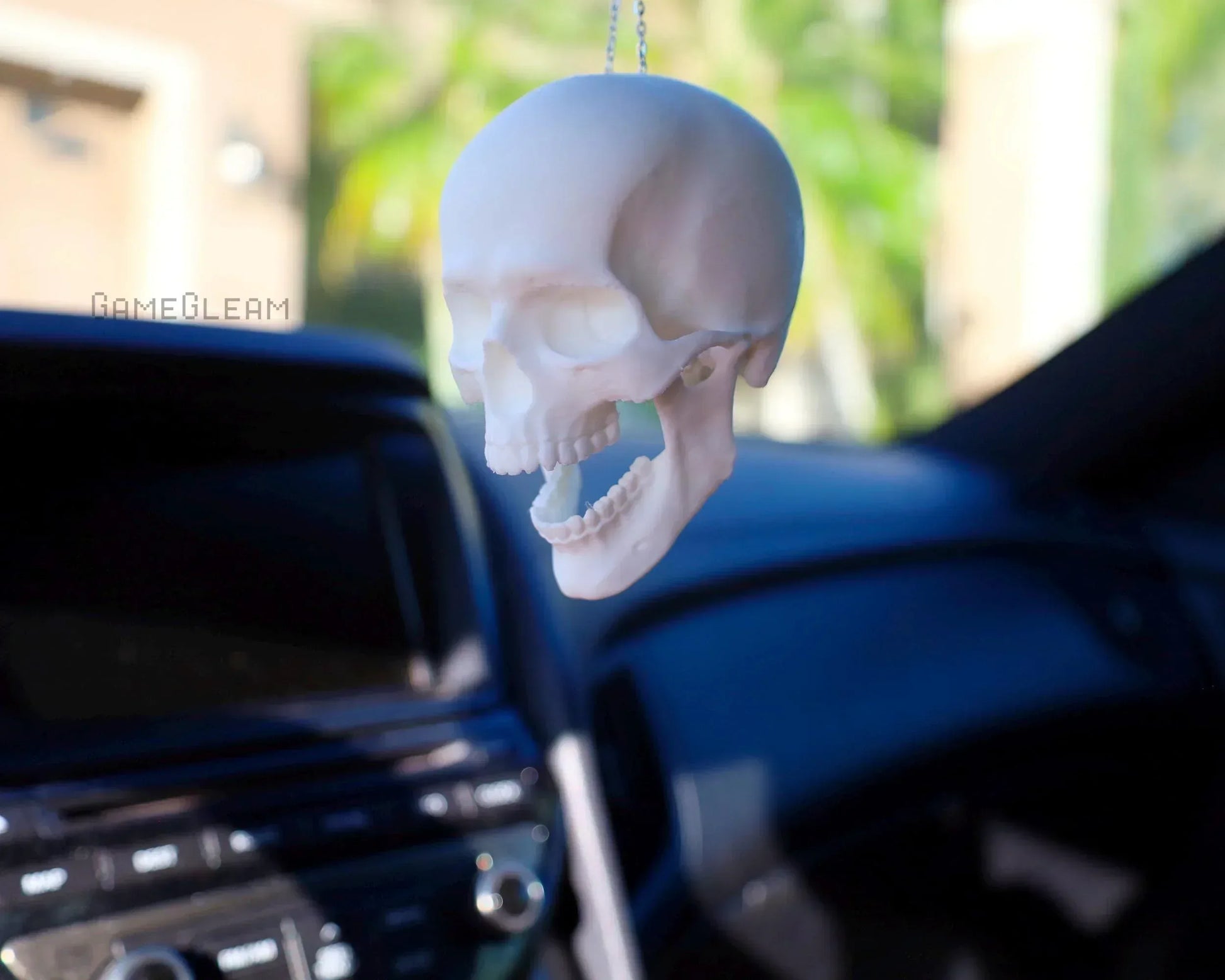 Handmade white skull car hanging ornament for gamers, displayed inside a vehicle