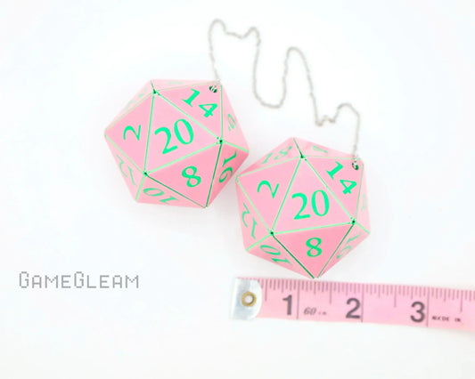 Pink 20-sided dice car accessories with green numbers and a measuring tape