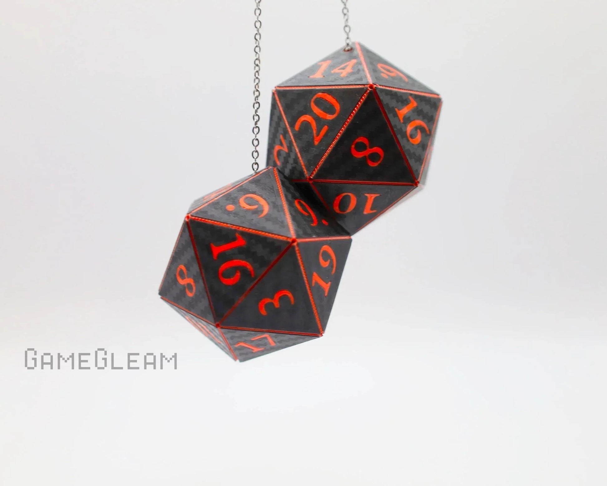 Pair of black 20-sided dice with red numbers hanging on a chain, gamer car accessory