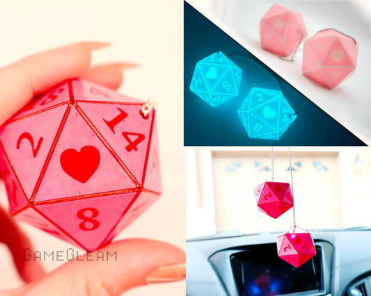 Pink 20-sided homemade dice charms with heart design, hanging from a car rearview mirror.