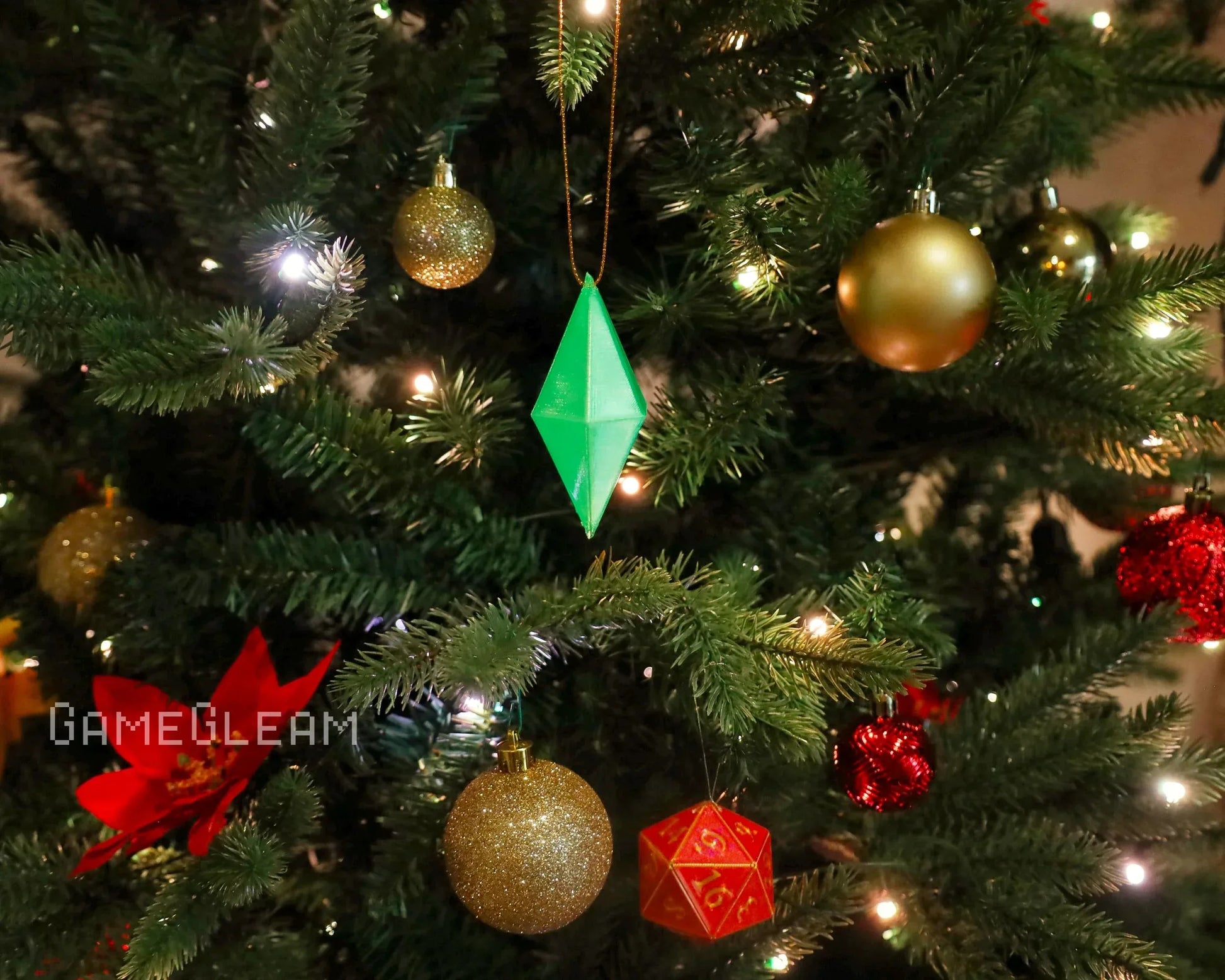 Christmas tree with green diamond ornament, gold baubles, red dice, and festive lights
