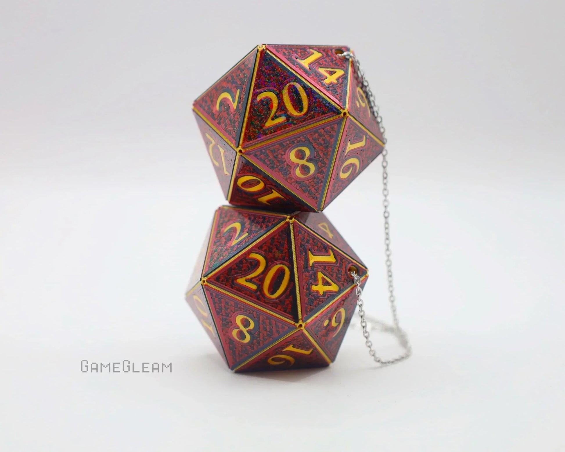 Pair of red holographic twenty-sided dice car charms with gold numbers and chain