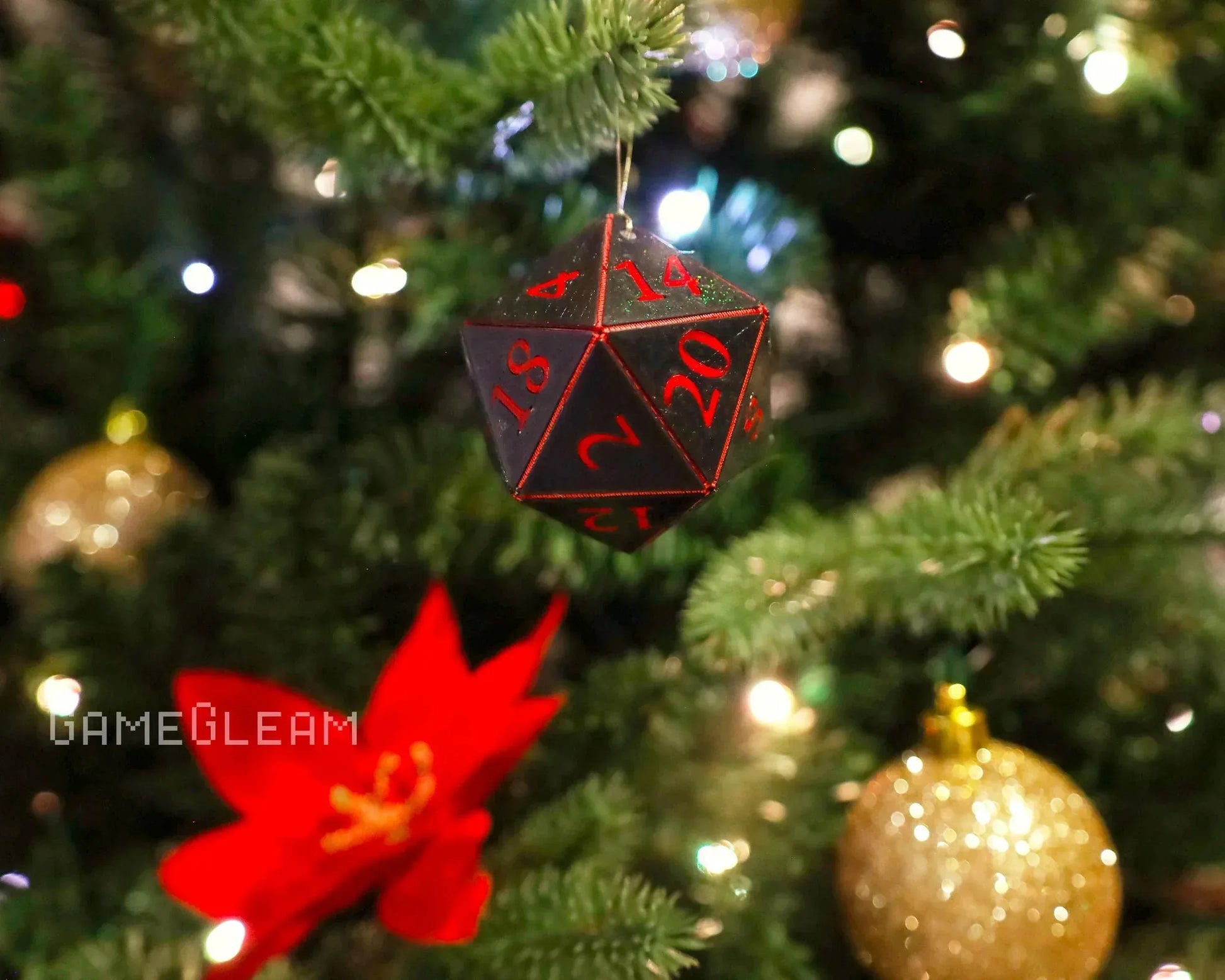 Black and red twenty-sided dice ornament hanging on a Christmas tree with festive decorations