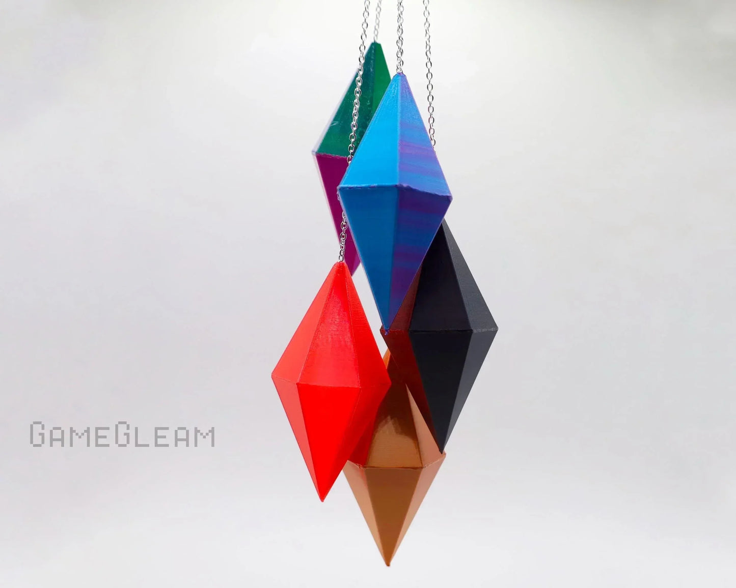 Colorful geometric polyhedral dice hanging as car dice charms on chains