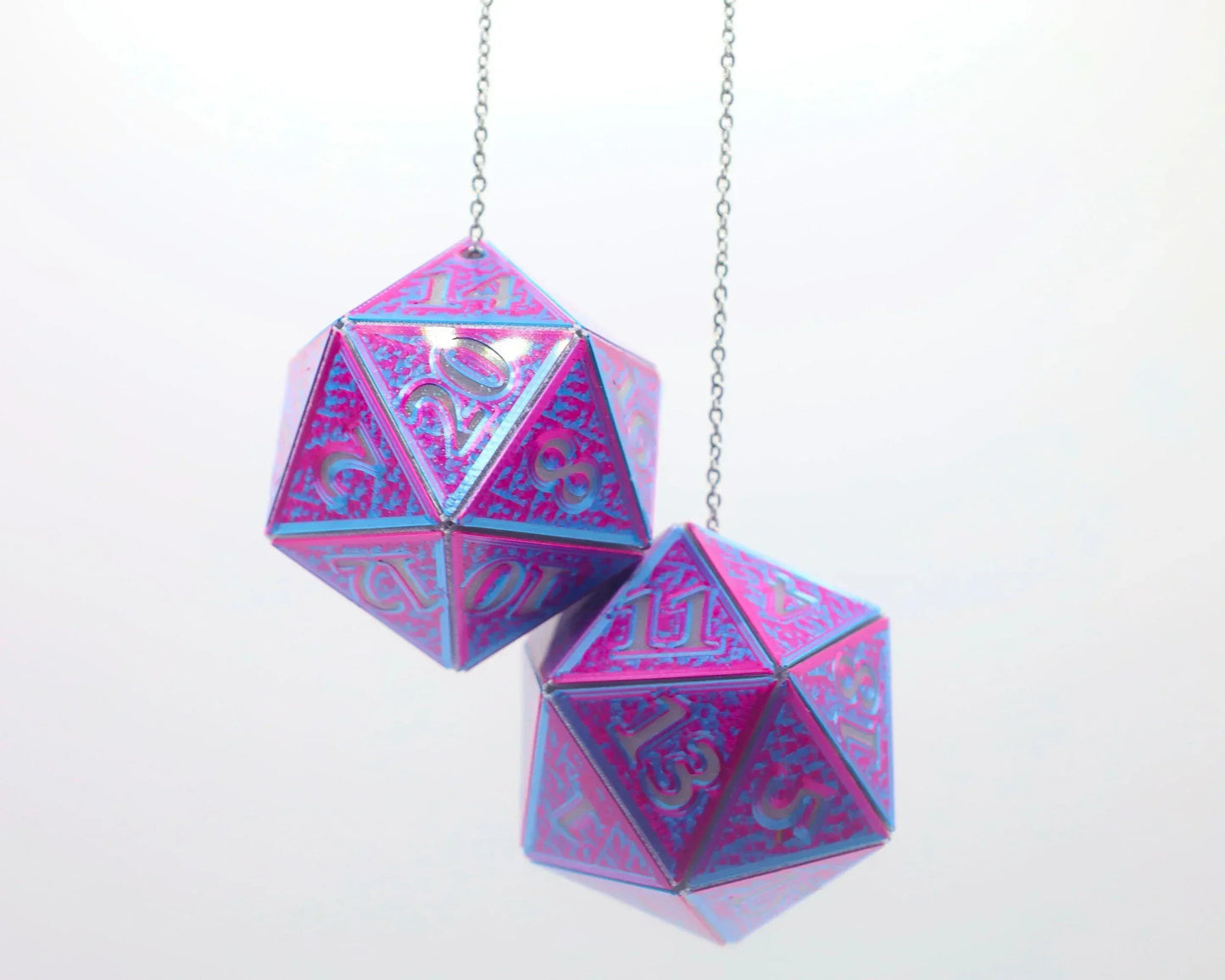 Holographic purple and blue twenty-sided dice hanging from chains, gamer car accessory