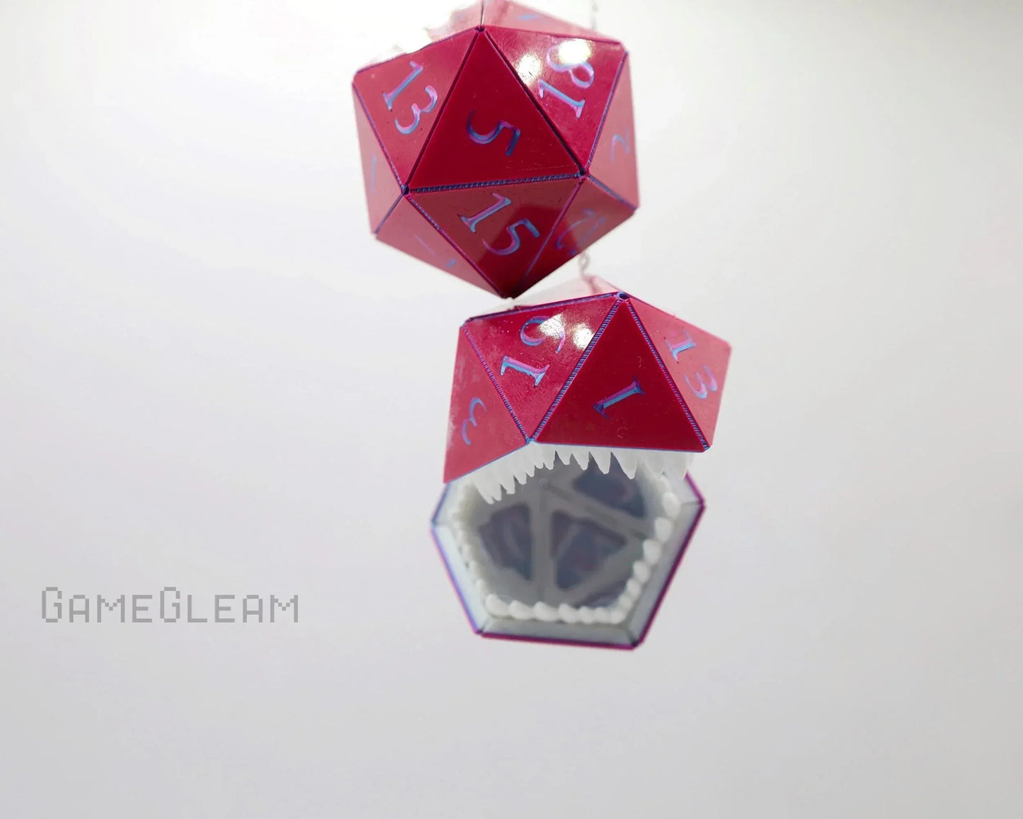 Red 20-sided dice car hanging charm with blue numbers and mimic monster teeth design