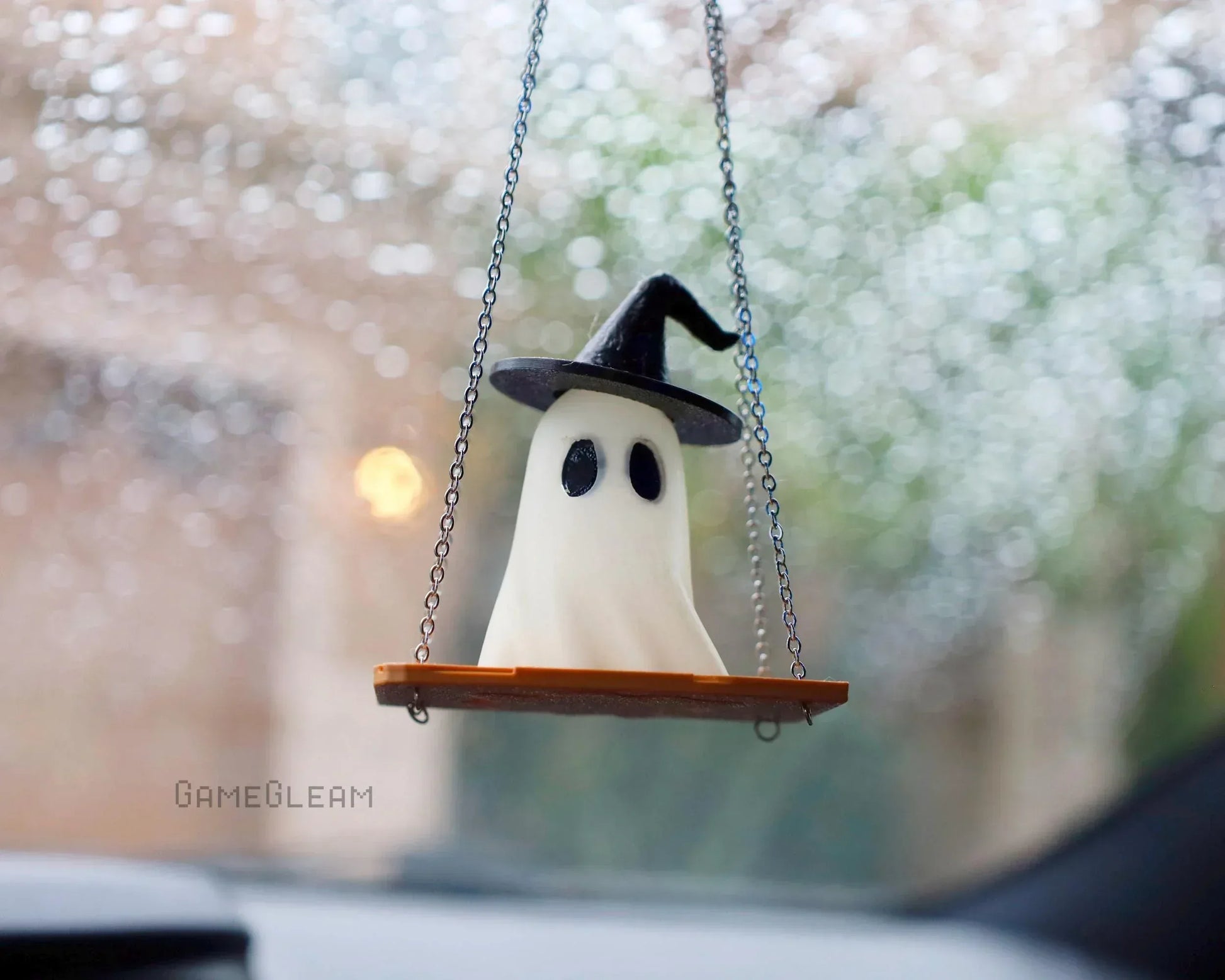 Handmade ghost car charm with witch hat on swing, hanging from rearview mirror