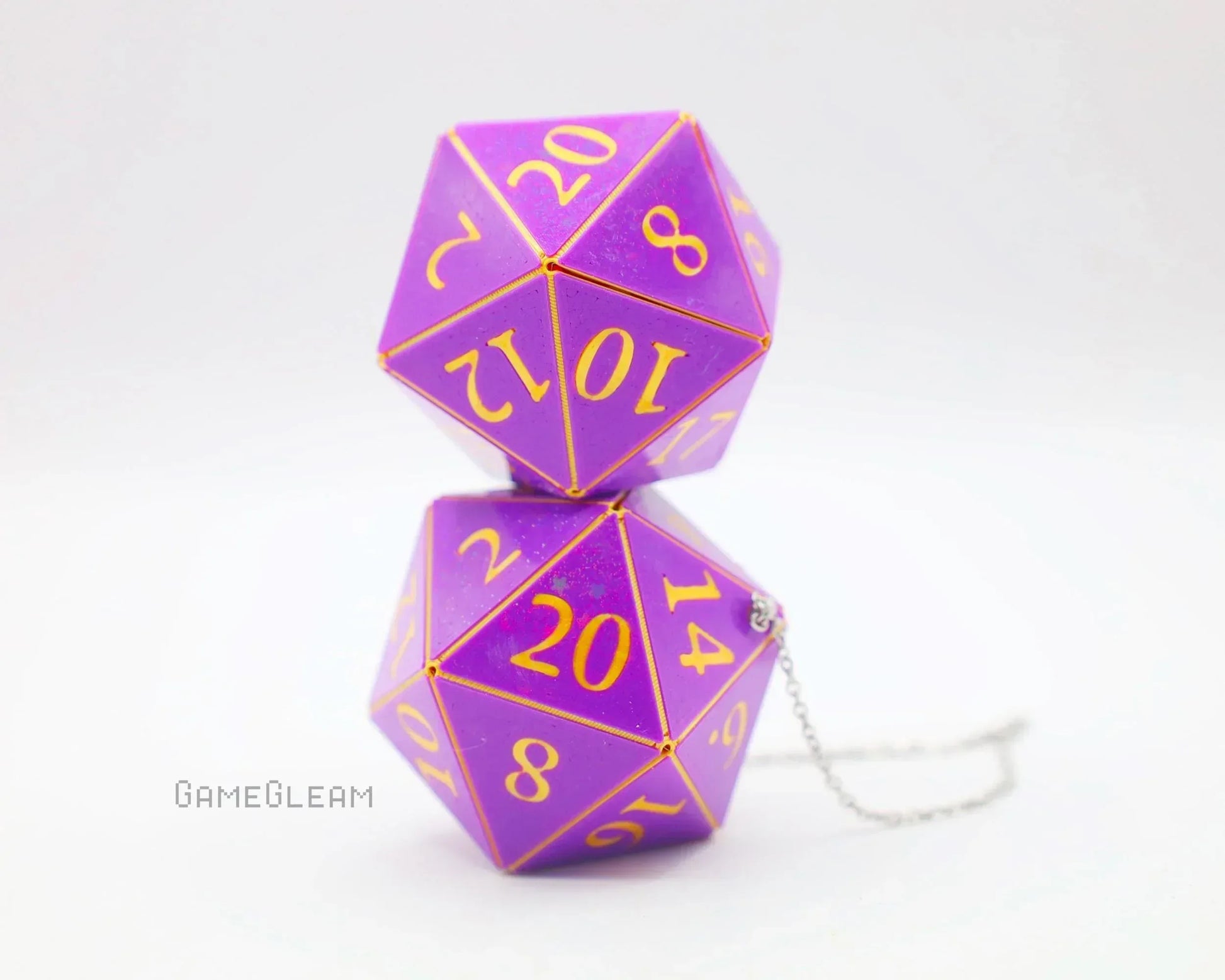 Purple twenty-sided dice car charm with gold numbers and silver chain on white background