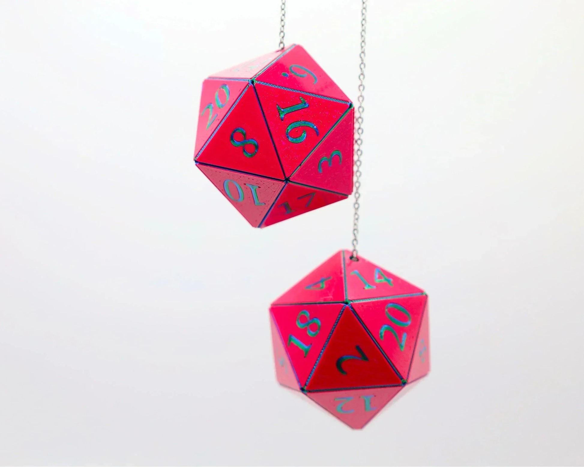 Pink twenty-sided dice charms with blue numbers hanging on chains, ideal for car decor or RPG gifts