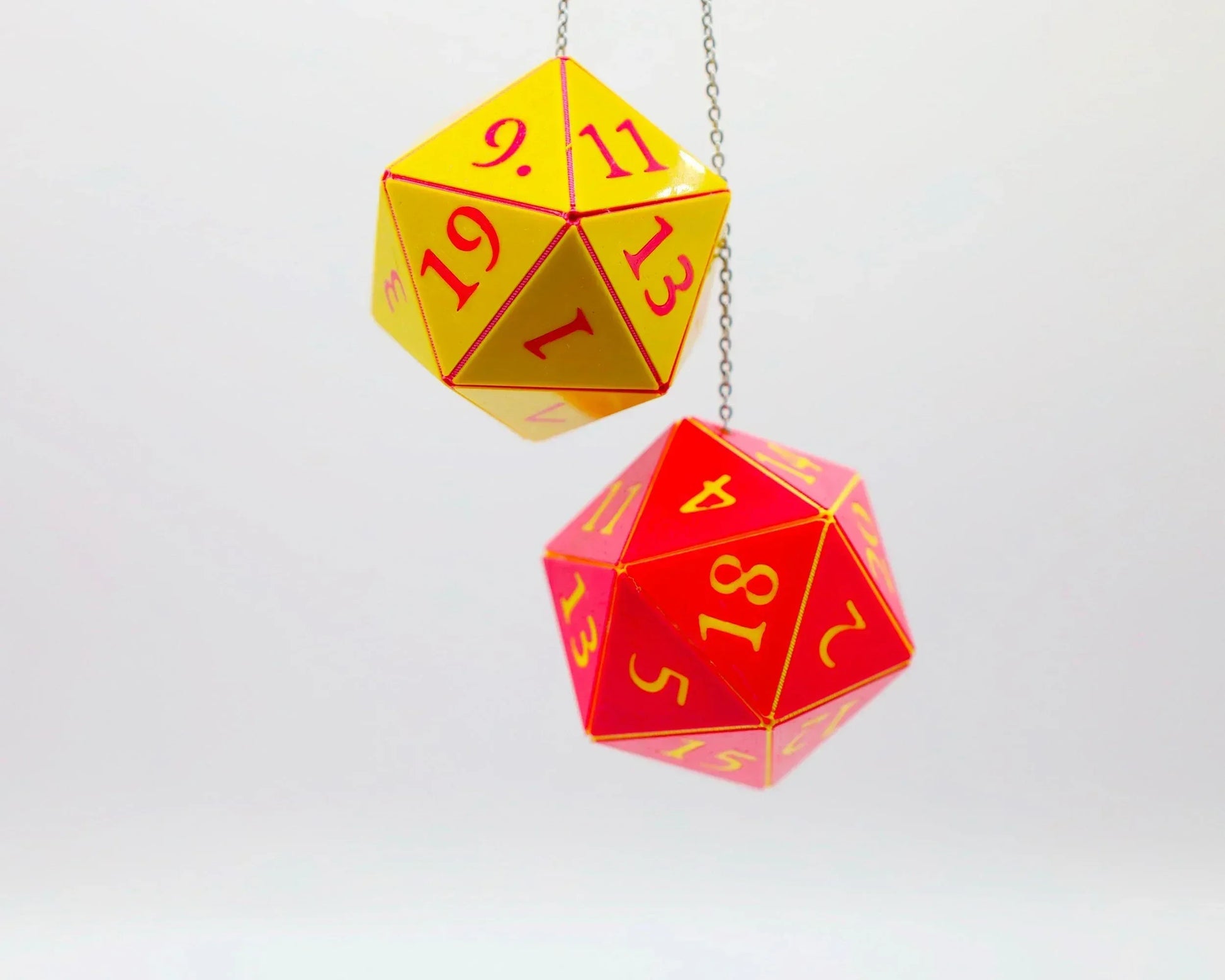 Yellow and red hanging twenty-sided dice charms with numbers for RPG car accessory