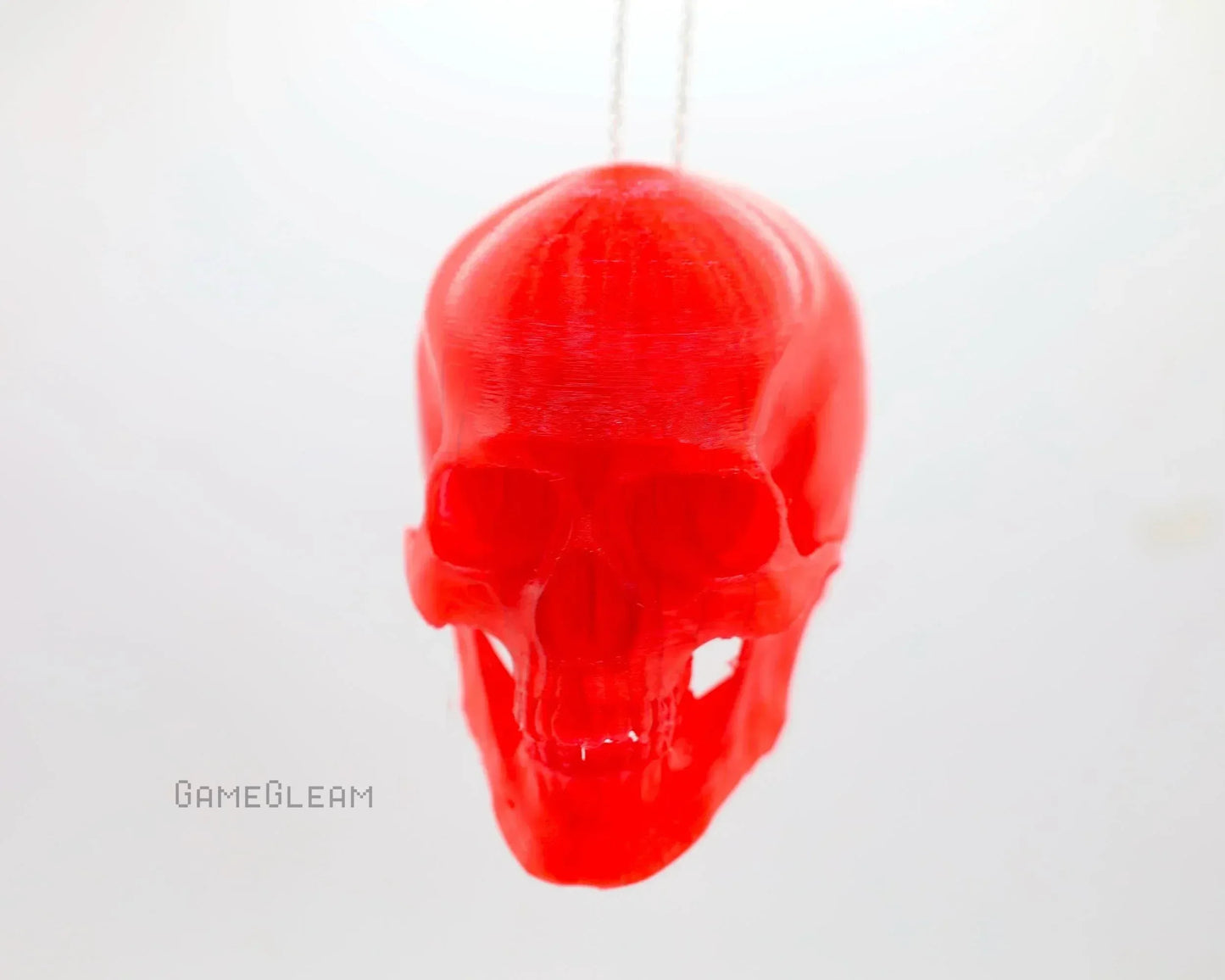 Red translucent skull car charm with a hanging chain, suitable for gamer decor