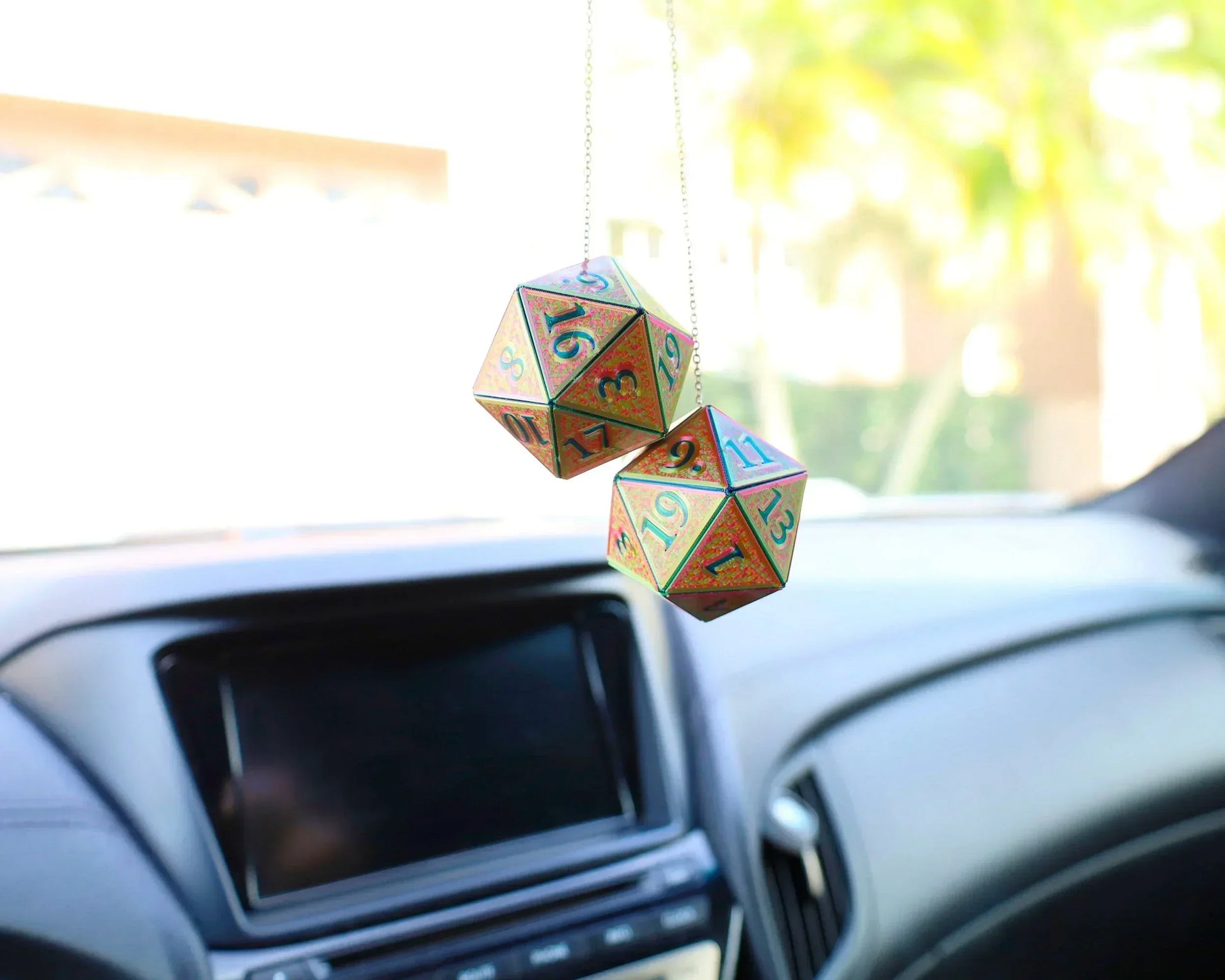 Holographic twenty-sided dice car charm hanging in a car interior, ideal gift for RPG fans