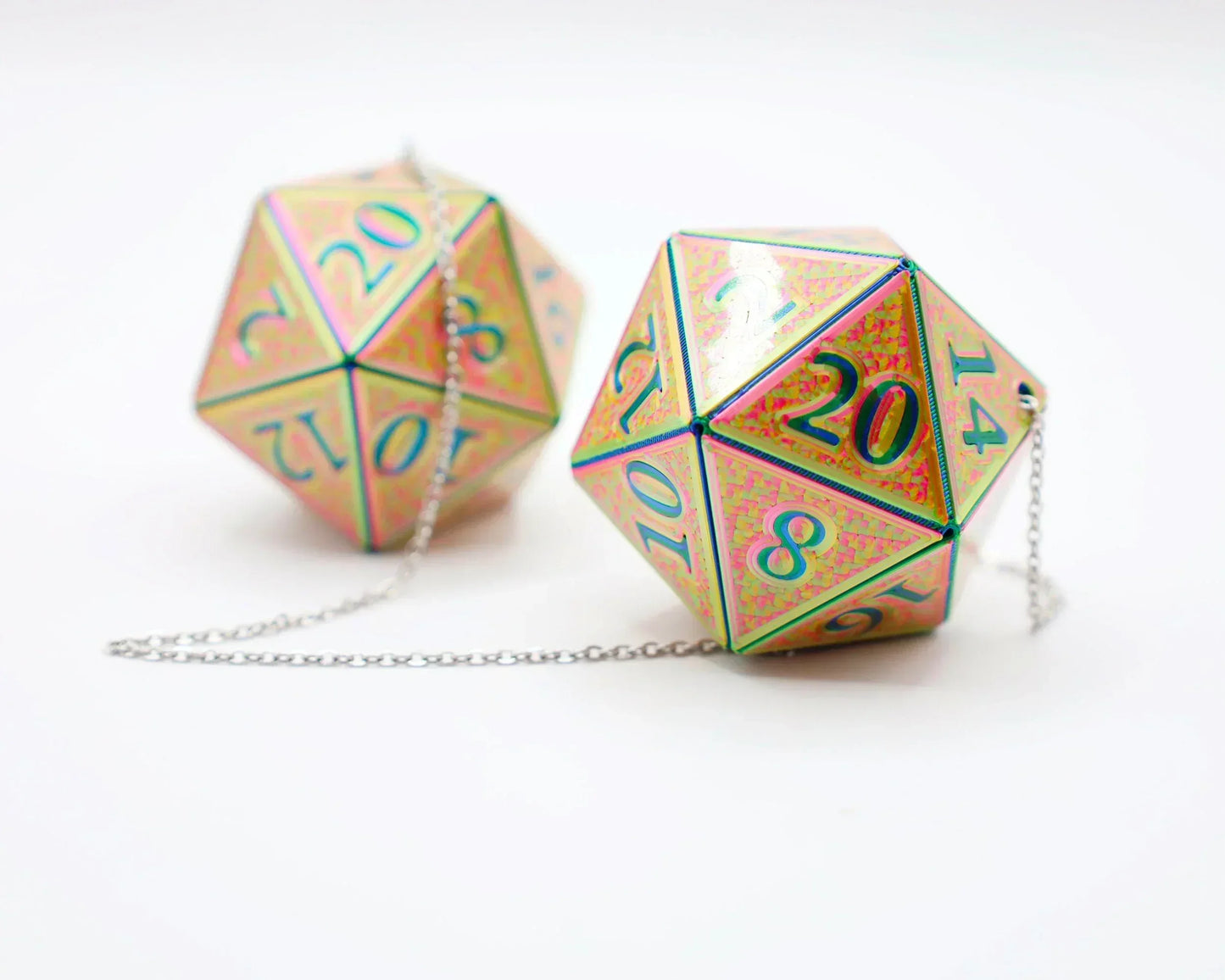 Holographic 20-sided dice car charms with iridescent finish and silver chain on white background