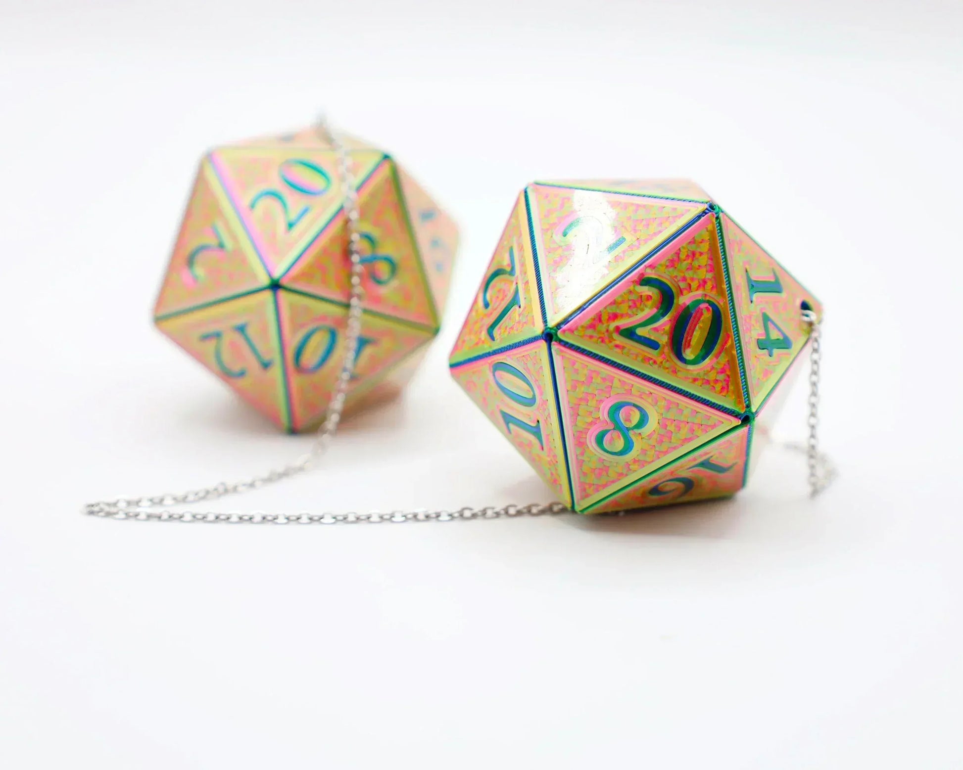 Holographic 20-sided dice car charms with iridescent finish and silver chain on white background