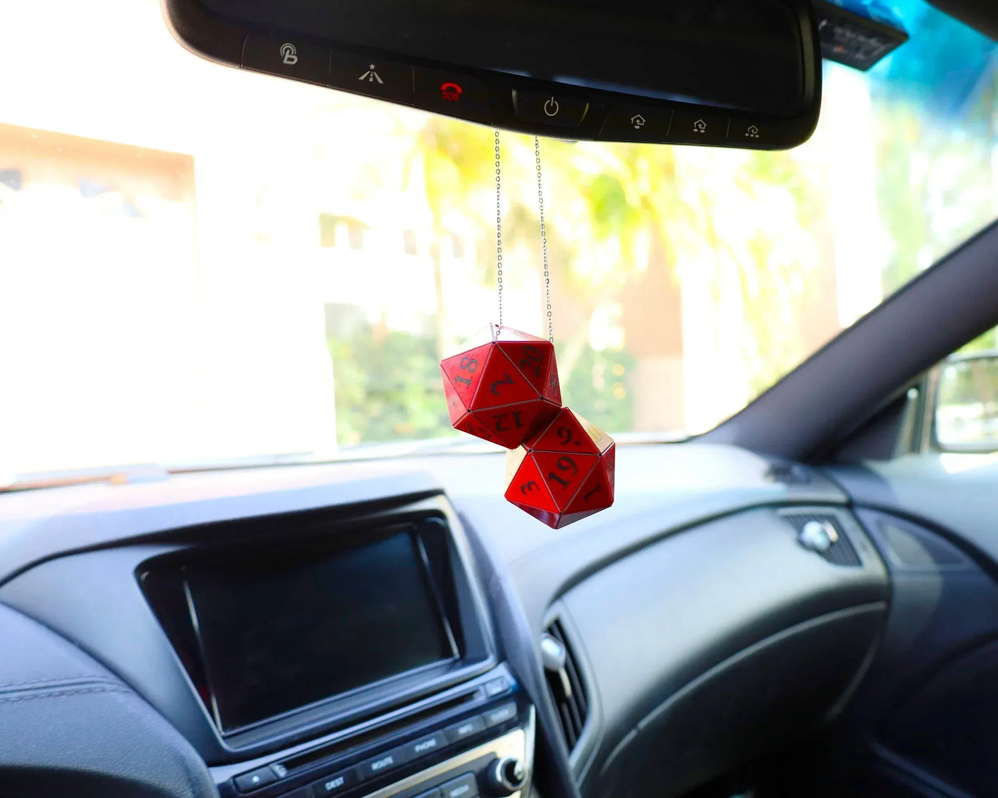 Red twenty-sided dice hanging as car mirror charm in modern vehicle interior