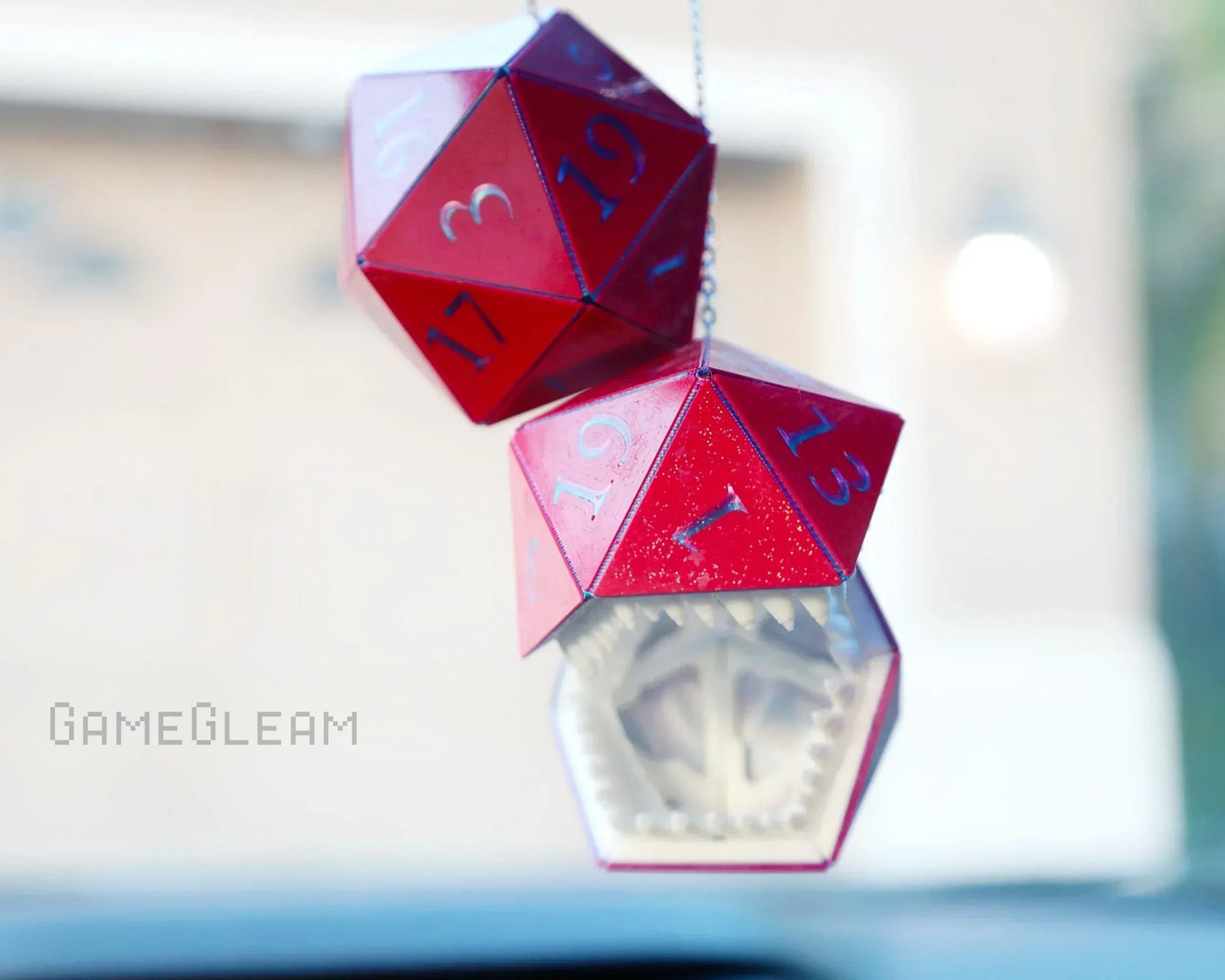 Hanging red twenty-sided dice car charm with teeth design, geek gift accessory for gamers.