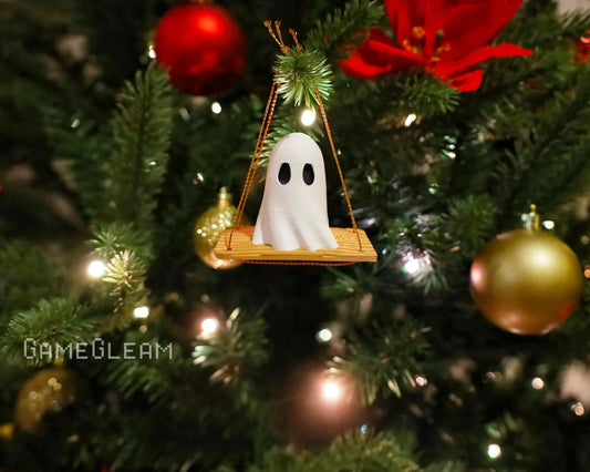 Handmade ghost ornament on swing hanging from decorated Christmas tree with lights and baubles