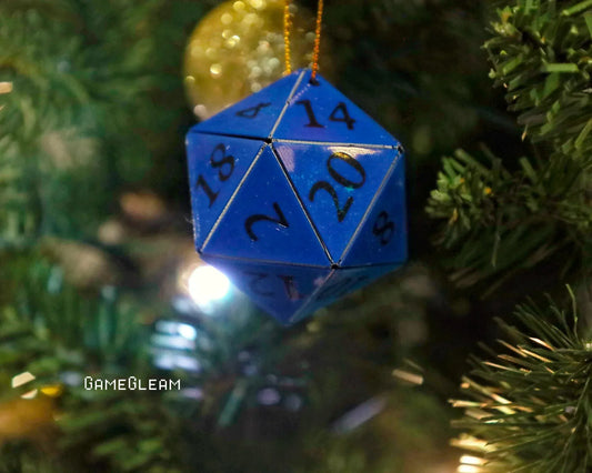 Blue twenty-sided dice ornament hanging on a Christmas tree with holiday lights