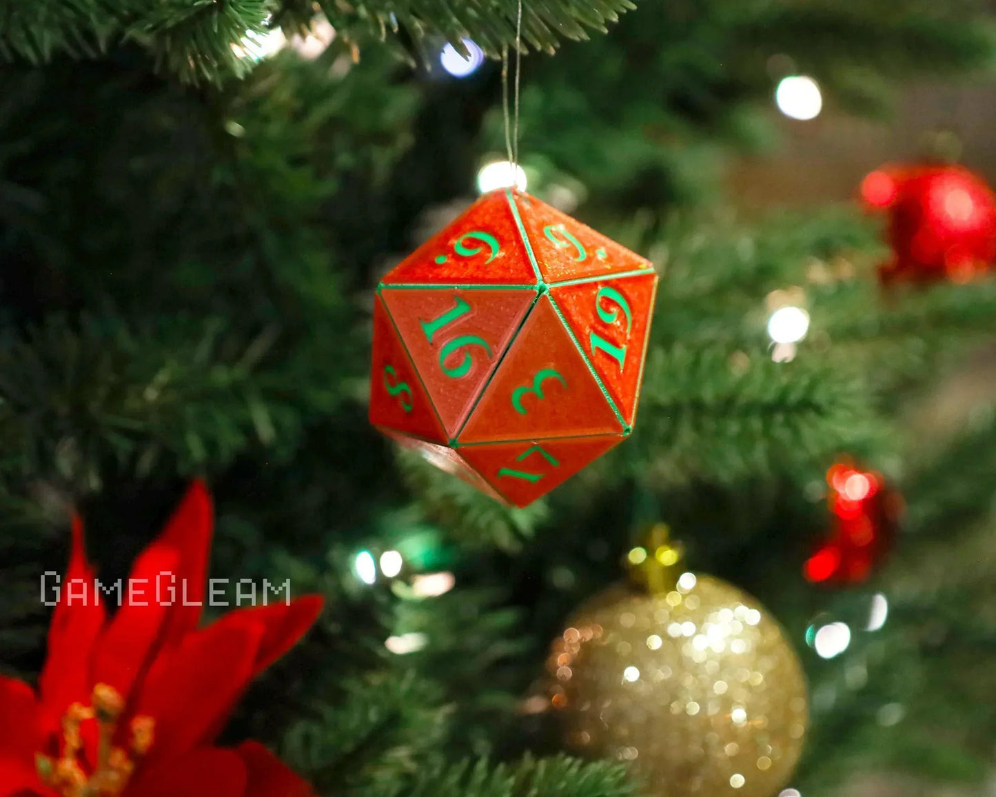 Red 20-sided dice ornament hanging on a Christmas tree with festive decorations