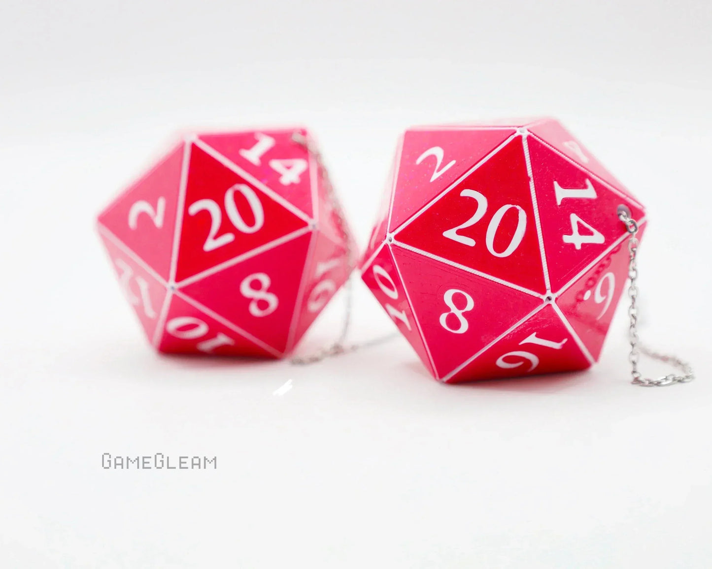 Pair of pink 20-sided dice charms with white numbers and metal chains for car accessory