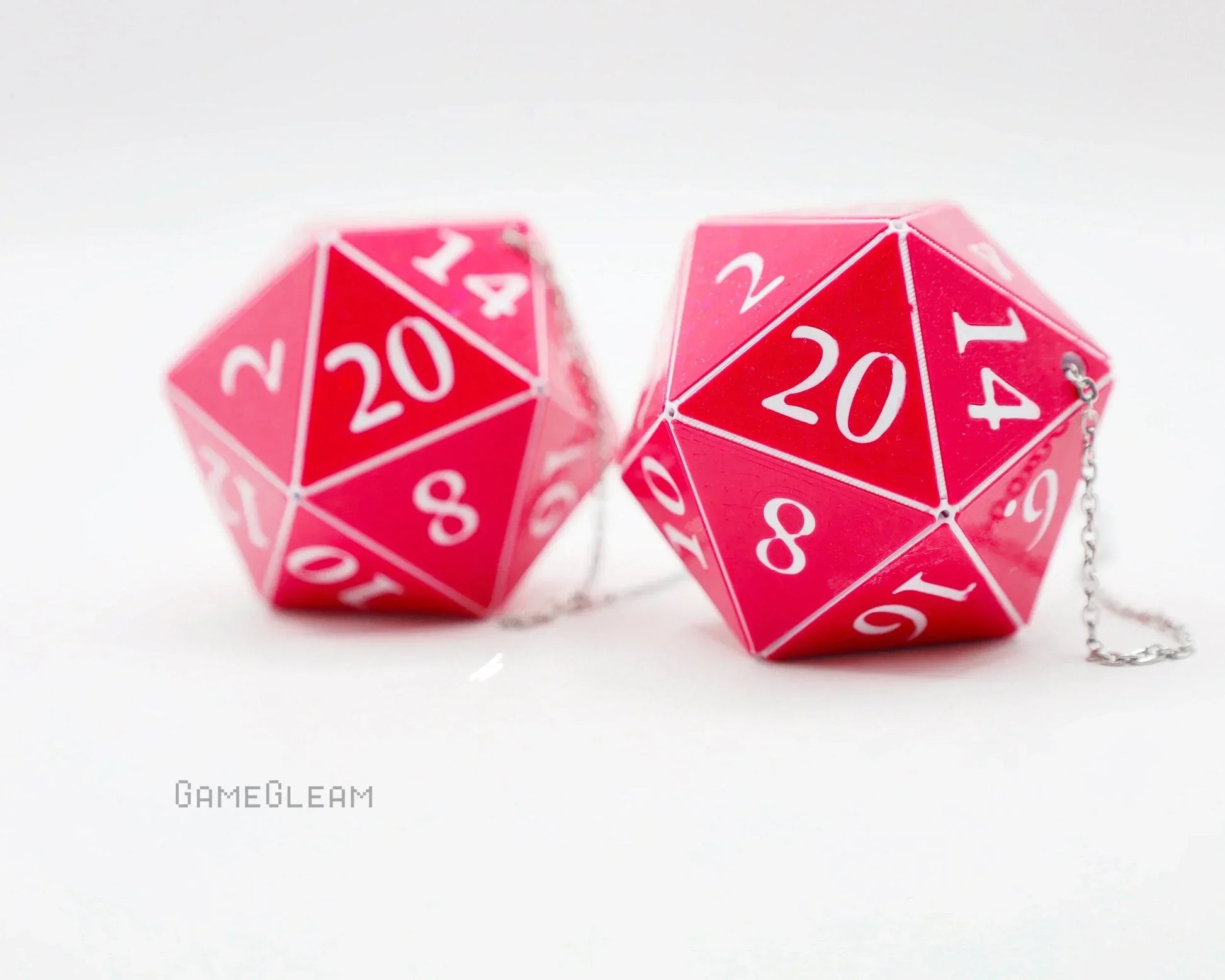 Pair of pink 20-sided dice charms with white numbers and metal chains for car accessory