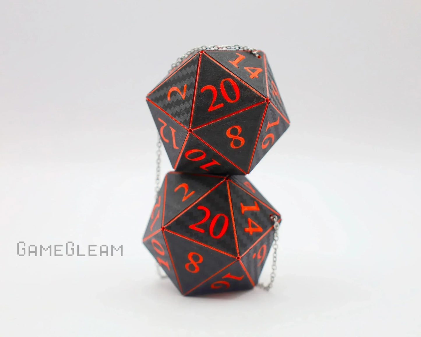 Pair of black 20-sided carbon fiber dice with red numbers and metal chain, gamer gift.