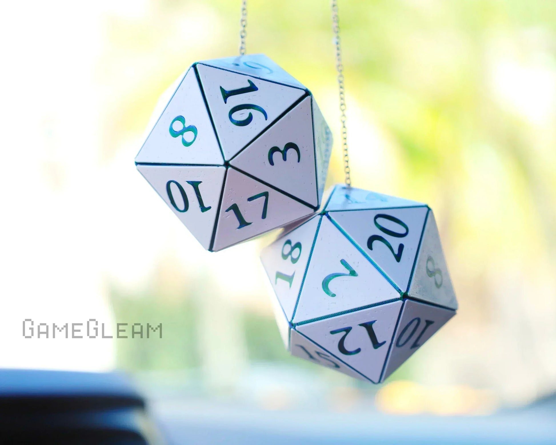 Pair of white twenty-sided dice car charms hanging on a chain, with numbers visible.