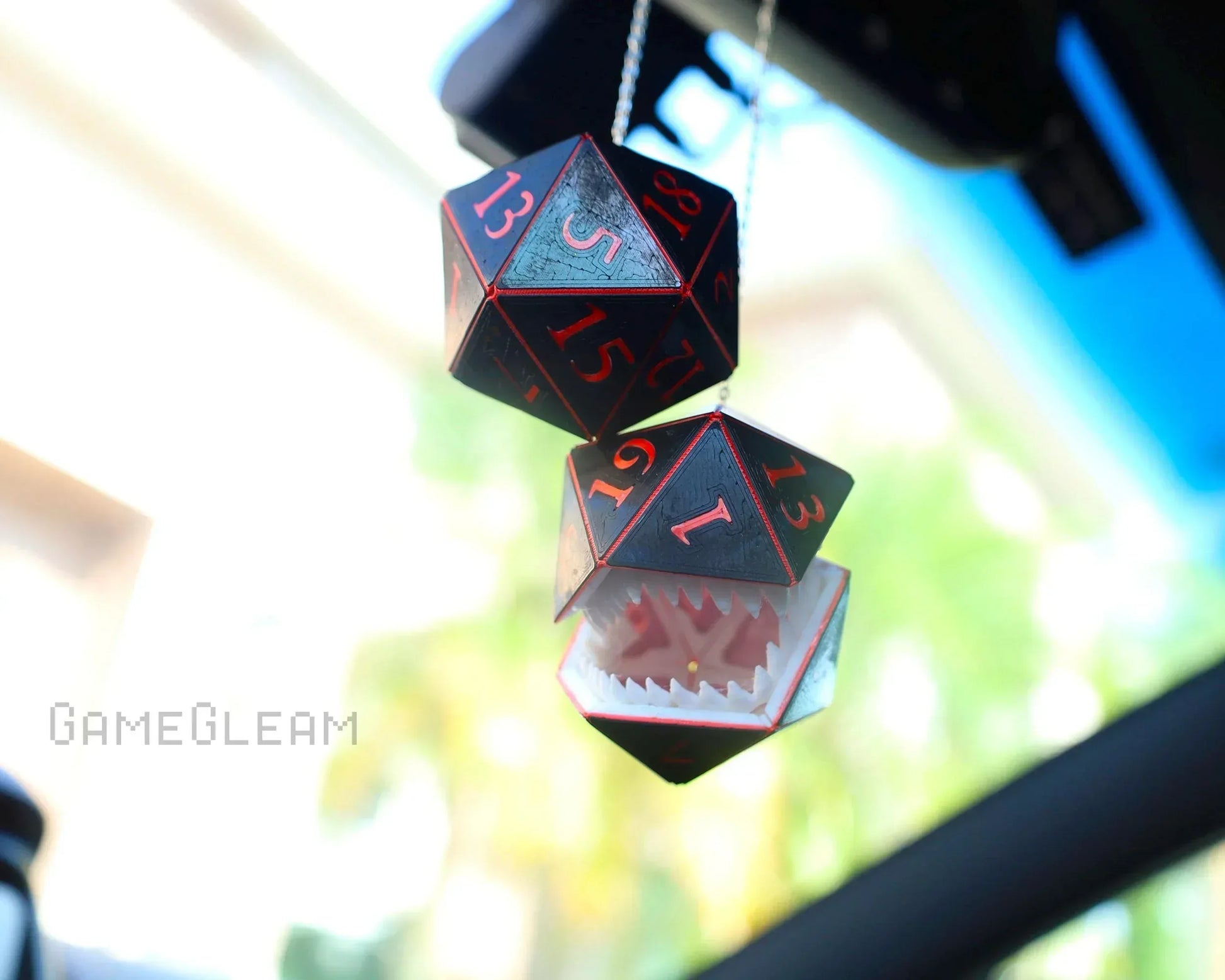 Handmade hanging car charm with black and red twenty-sided dice and a dice mimic design