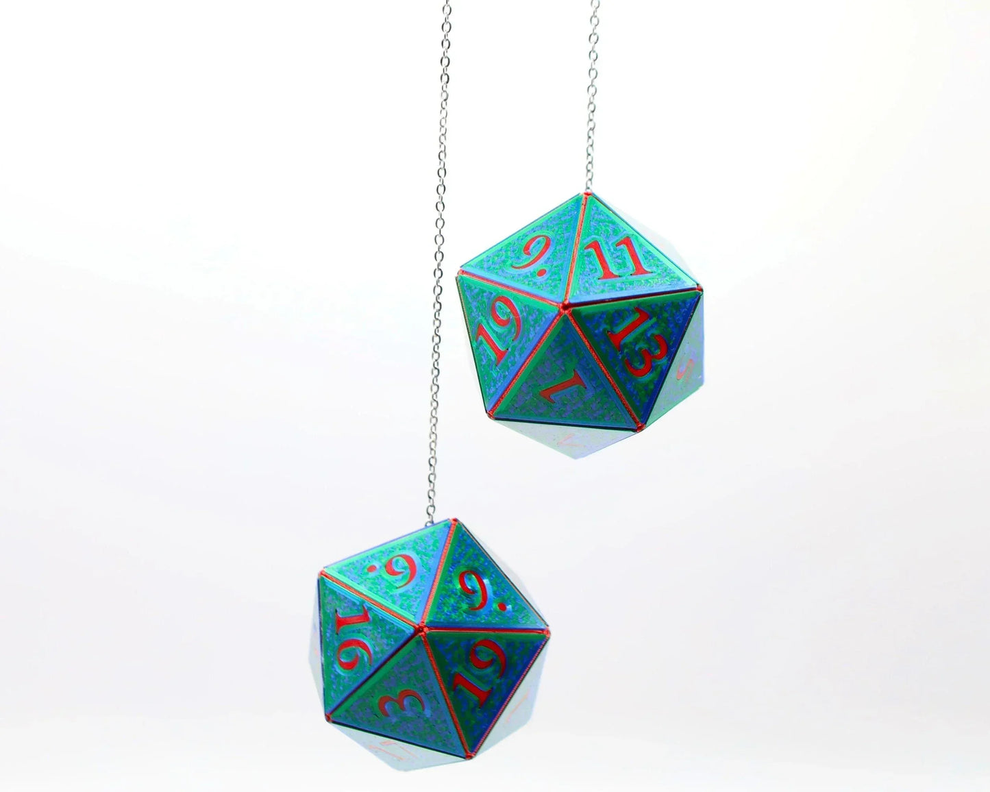 Holographic teal twenty-sided dice hanging as car mirror charms for tabletop gamers