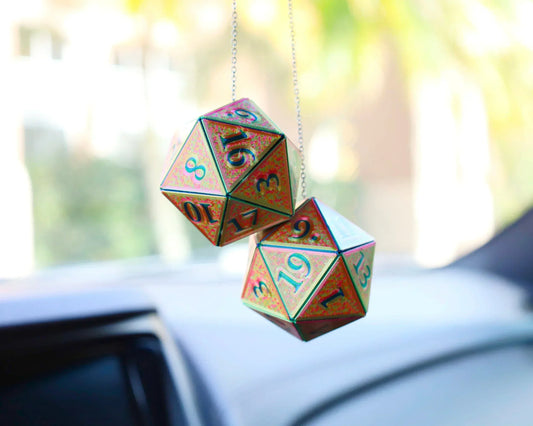 Holographic twenty-sided dice car charms hanging from a rearview mirror.