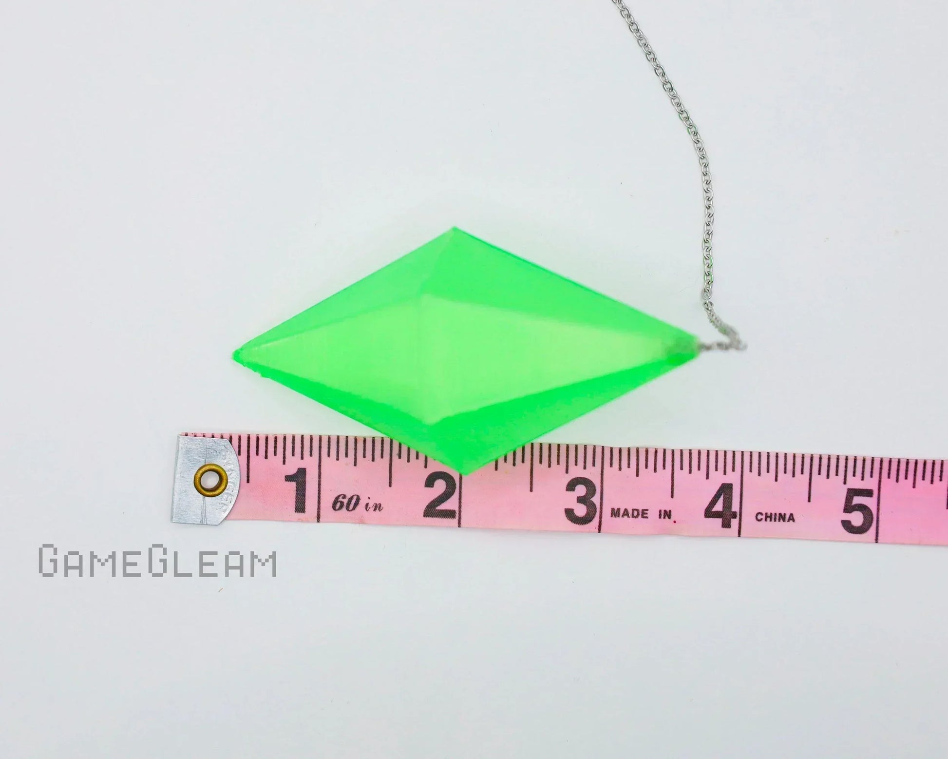 Green acrylic diamond-shaped car charm pendant with silver chain and tape measure for scale
