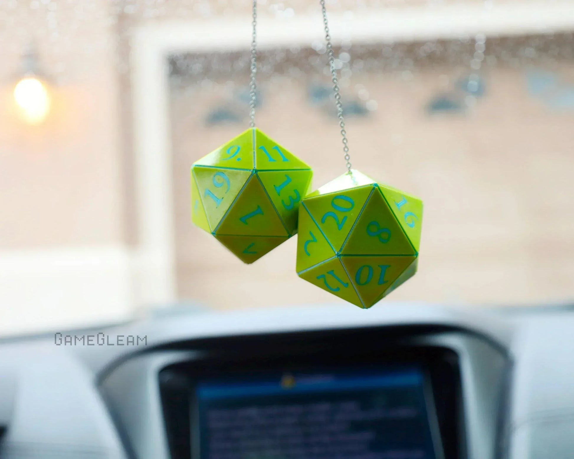 Green twenty-sided dice charms hanging from car rearview mirror, gamer car accessory