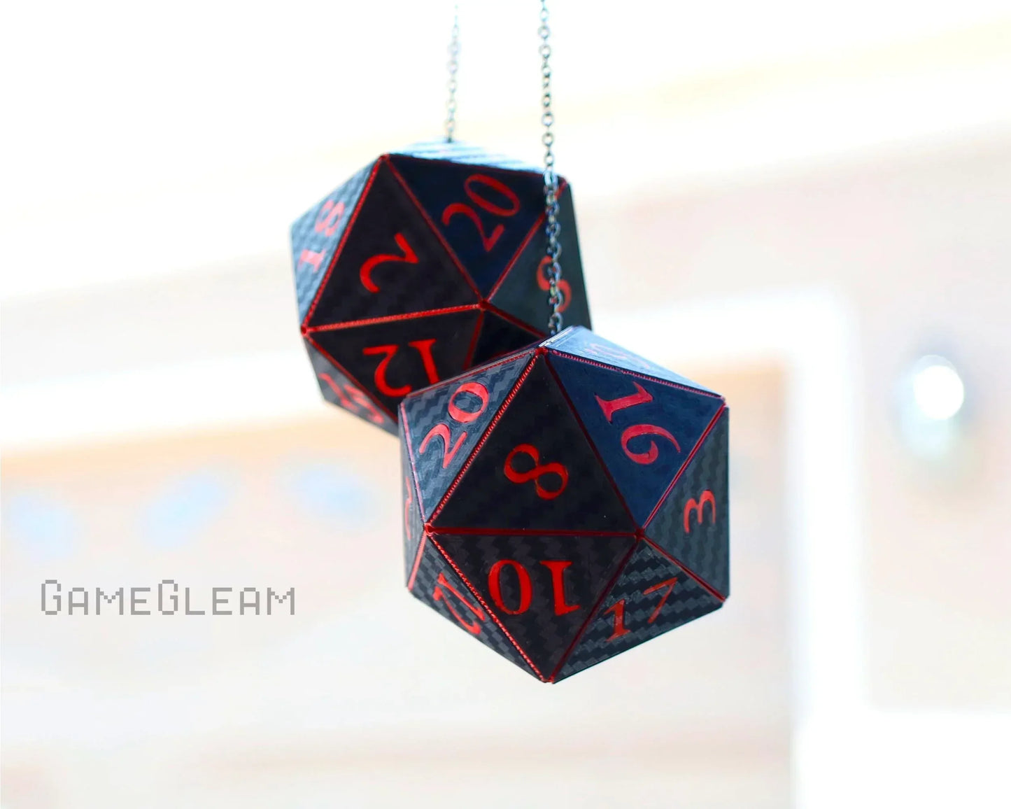 Hanging pair of black and red twenty-sided dice car charms for tabletop gaming fans