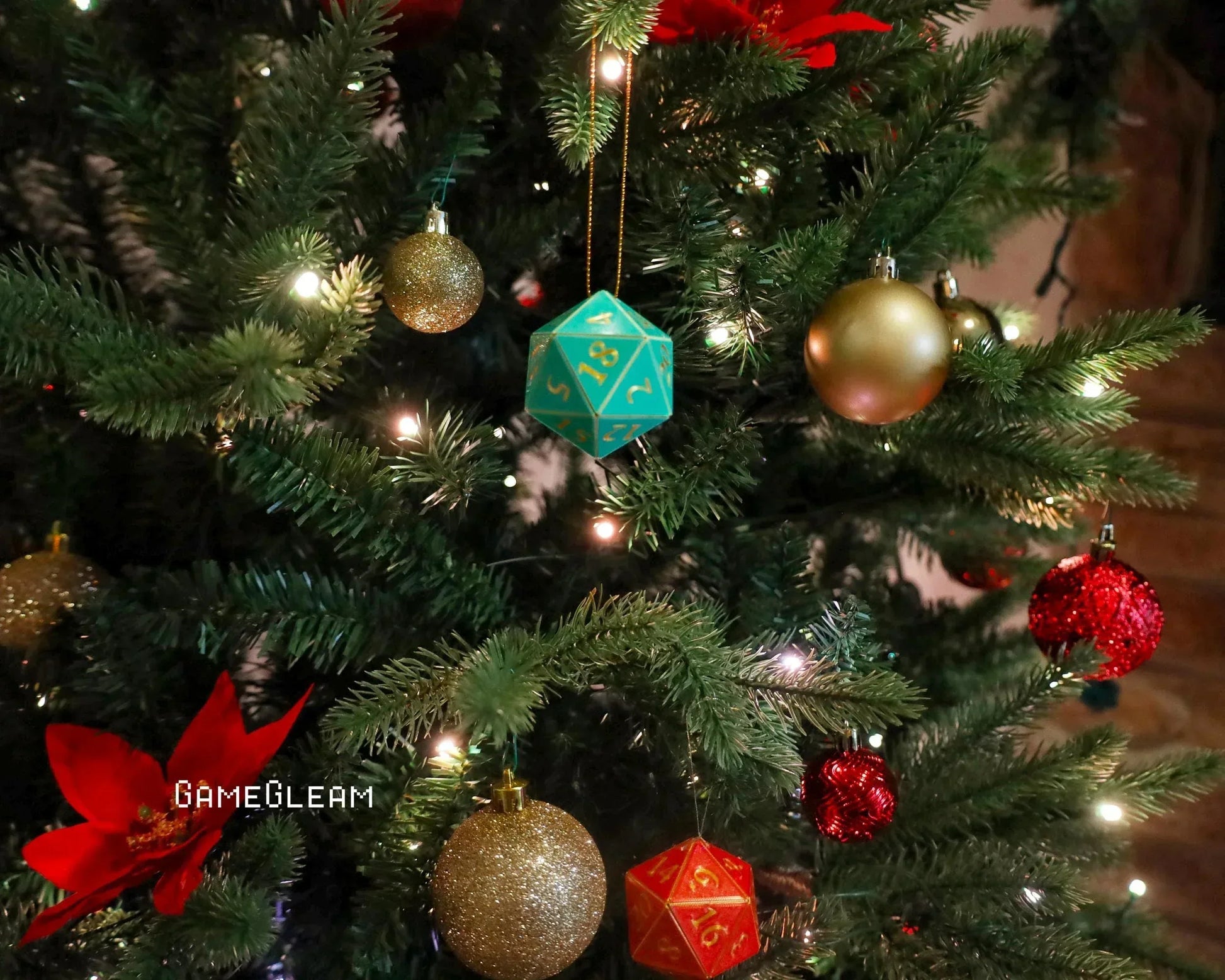 Teal twenty-sided dice ornament and gold baubles on a decorated Christmas tree with lights