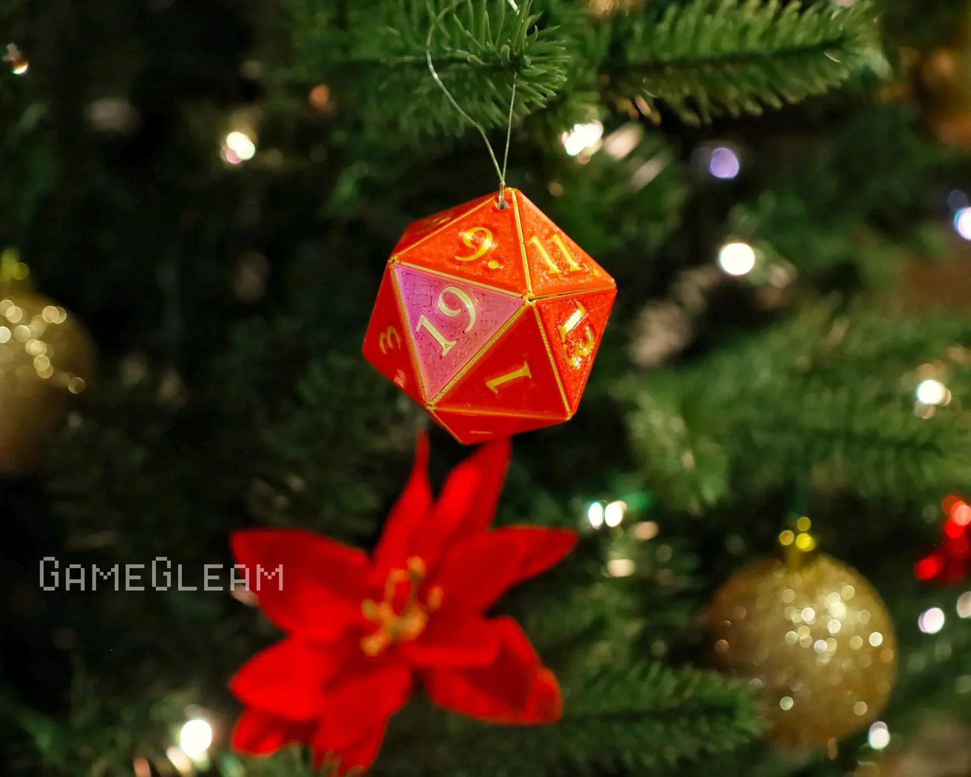 Red and gold twenty-sided dice ornament hanging on Christmas tree with festive decorations
