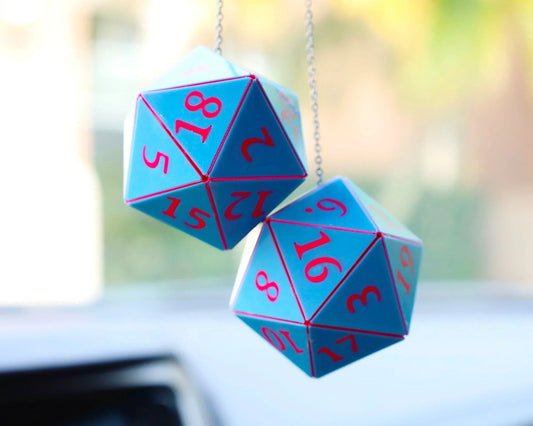 Blue and pink twenty-sided dice car charm hanging from a rearview mirror