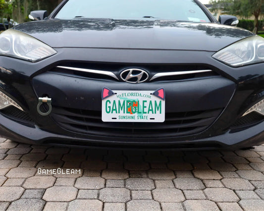 Front of a black Hyundai car with a custom Florida license plate that reads GAMEGLEAM.