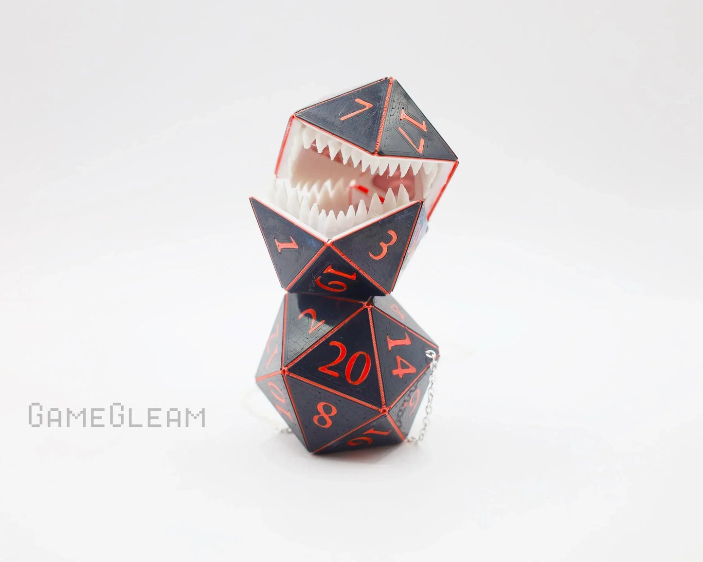 Handmade gamer gift with two black and red polyhedral dice, one with teeth and a chain