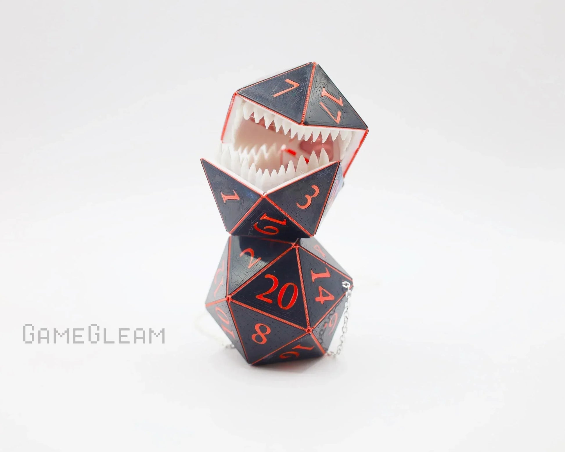 Handmade gamer gift with two black and red polyhedral dice, one with teeth and a chain