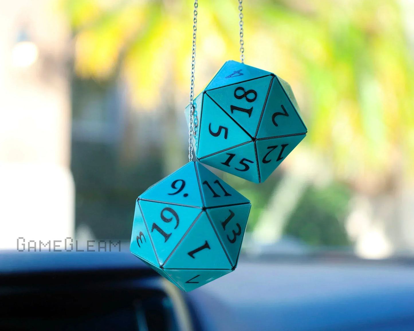 Blue twenty-sided dice car charm for tabletop gaming fans hanging from rearview mirror