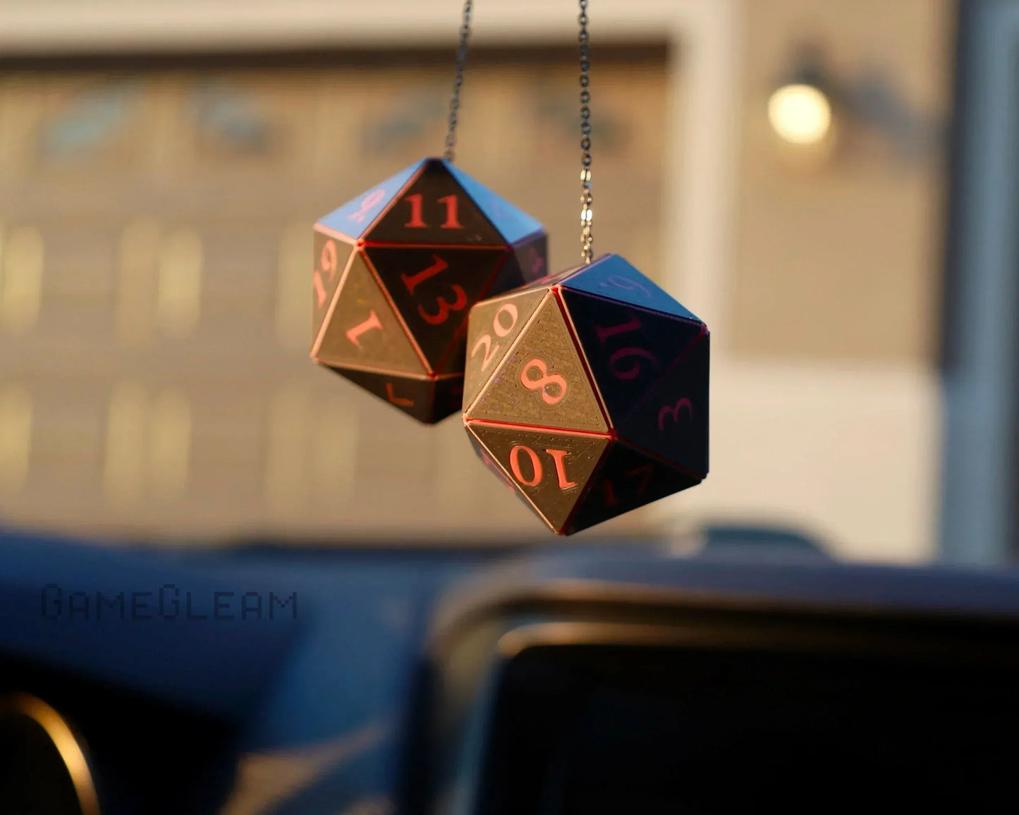 Handmade black and red twenty-sided dice car charm hanging from rearview mirror
