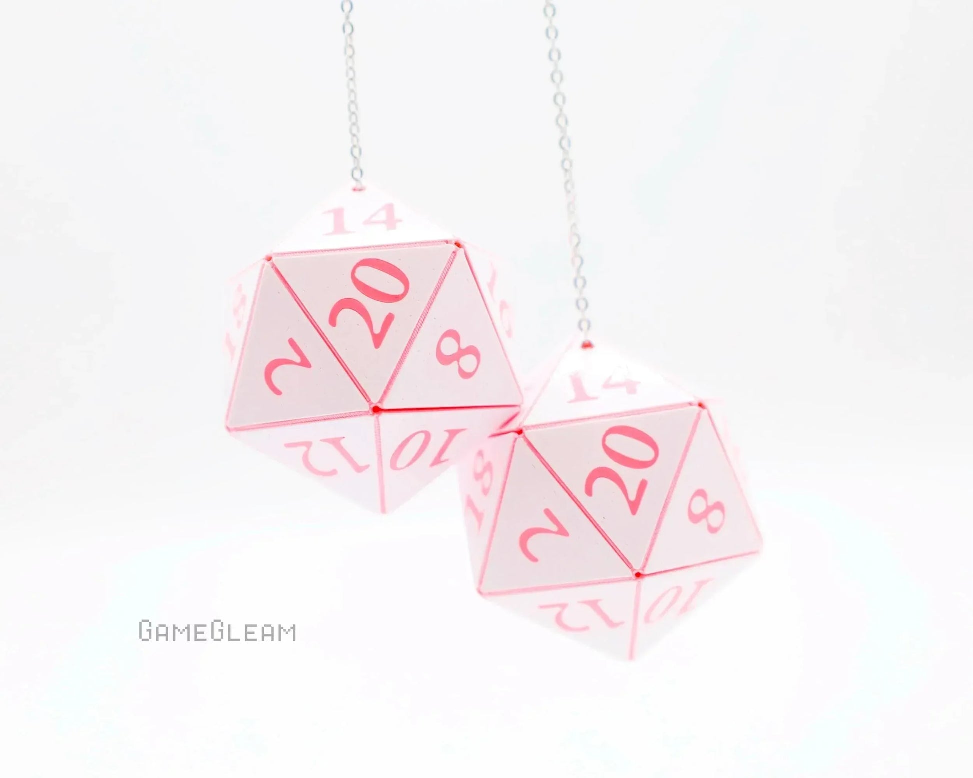 Pair of pink and white twenty-sided dice hanging as car mirror charms