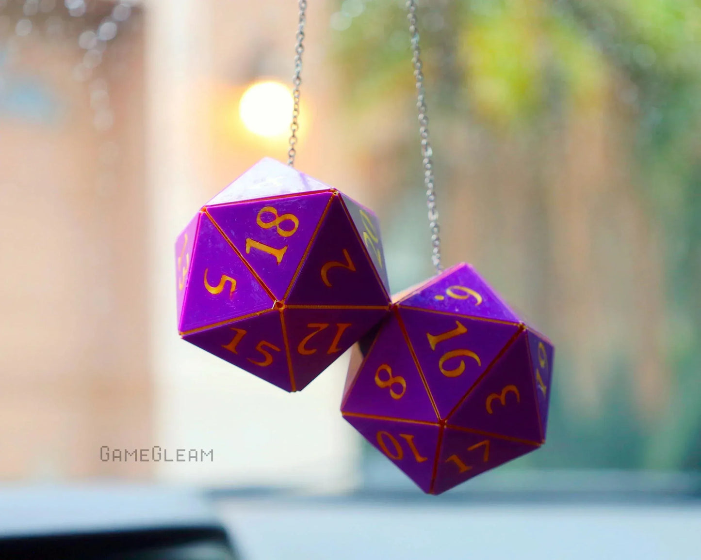 Purple twenty-sided dice car mirror charm with yellow numbers, hanging on a chain