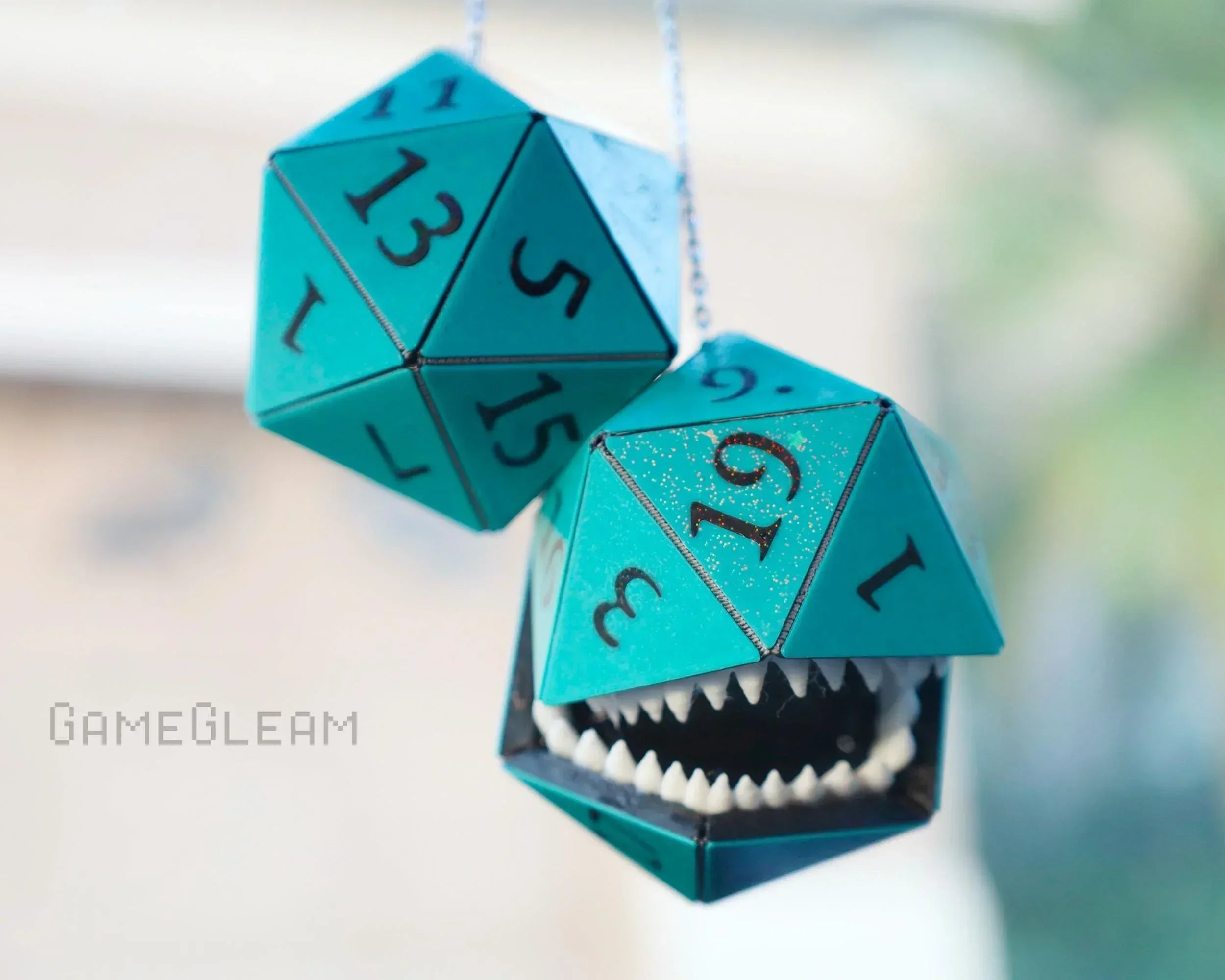 Teal 20-sided dice car charm with one die featuring sharp teeth, handmade RPG accessory