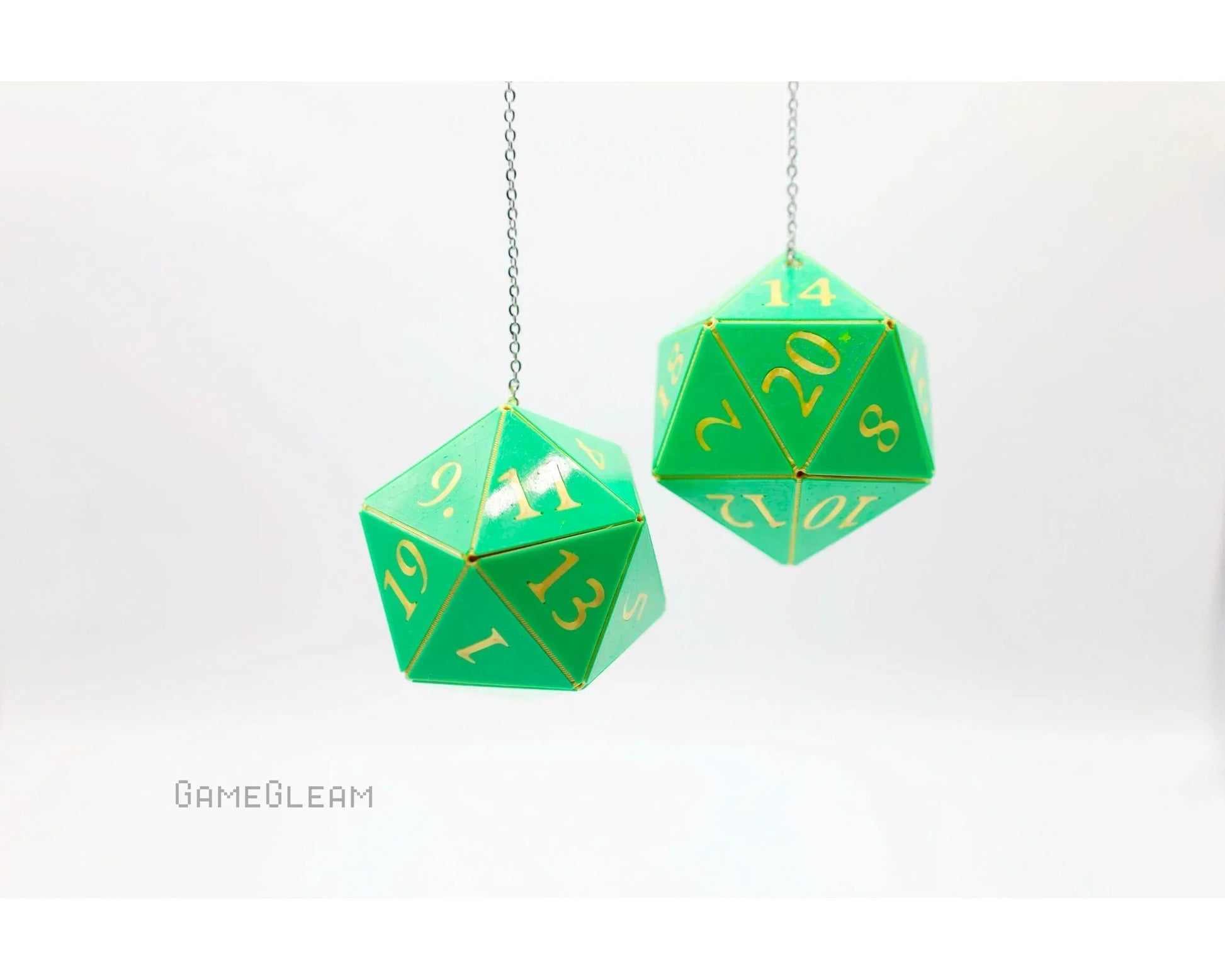 Green twenty-sided dice car charms with gold numbers hanging on silver chains