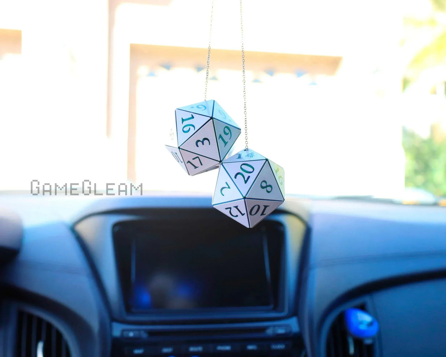 Holographic twenty-sided dice car charms hanging on rearview mirror in vehicle interior