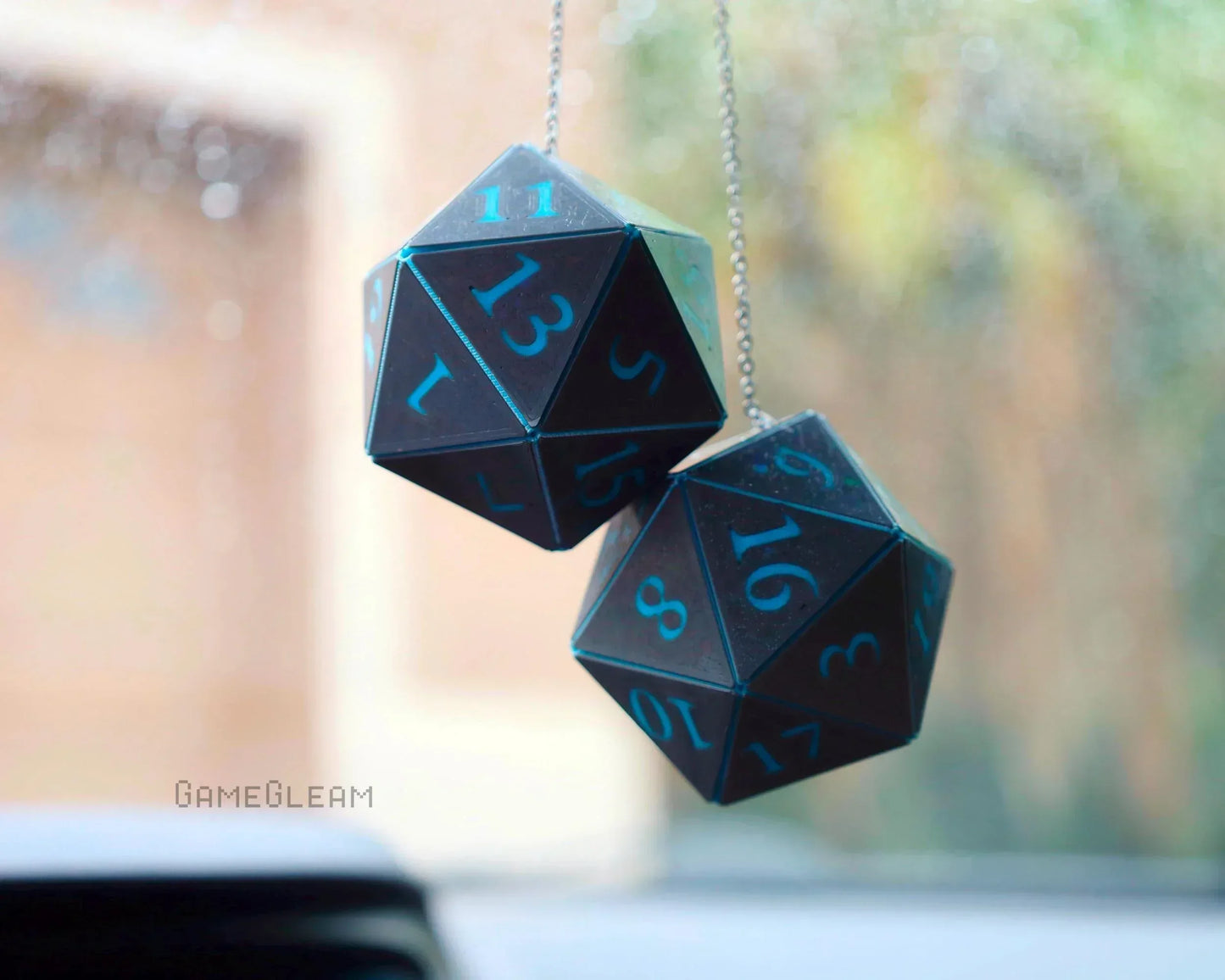 Hanging holographic blue and black twenty-sided dice car charm for tabletop gaming fans