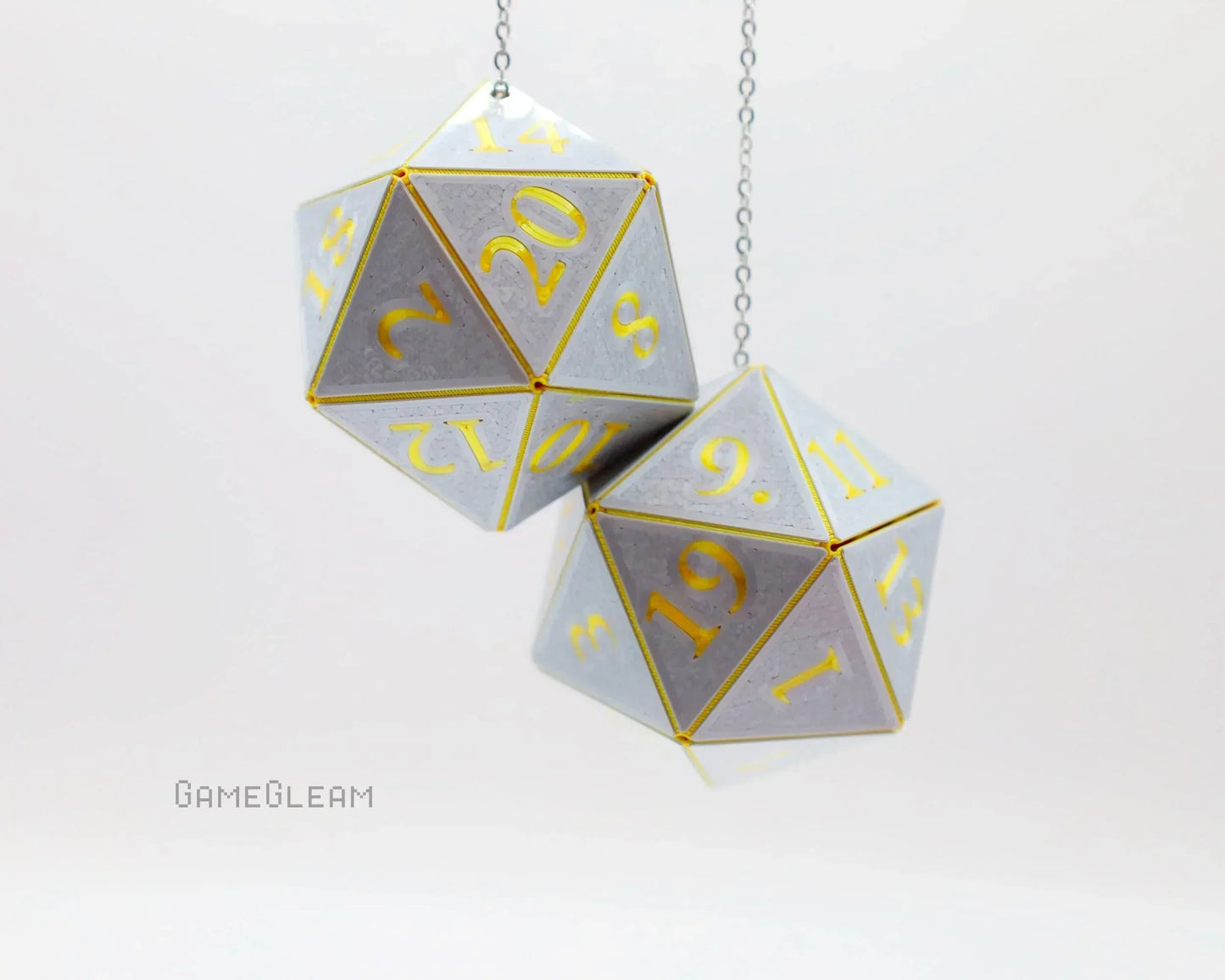 Handmade silver and gold twenty-sided dice car charm for tabletop RPG fans, hanging on chains.